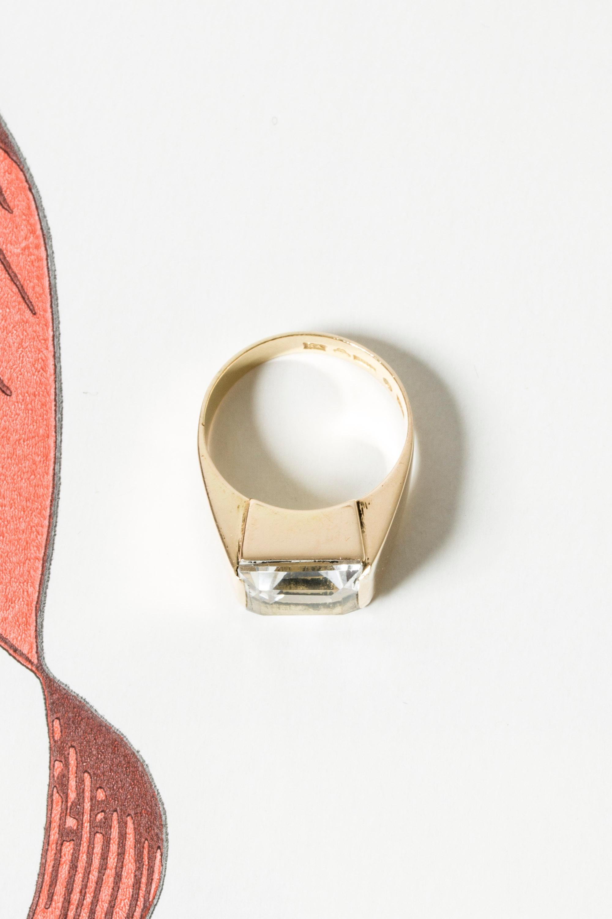 Striking gold ring from Stigbert, with a baguette cut rock crystal stone. Elegant, timeless design with a crisp look.