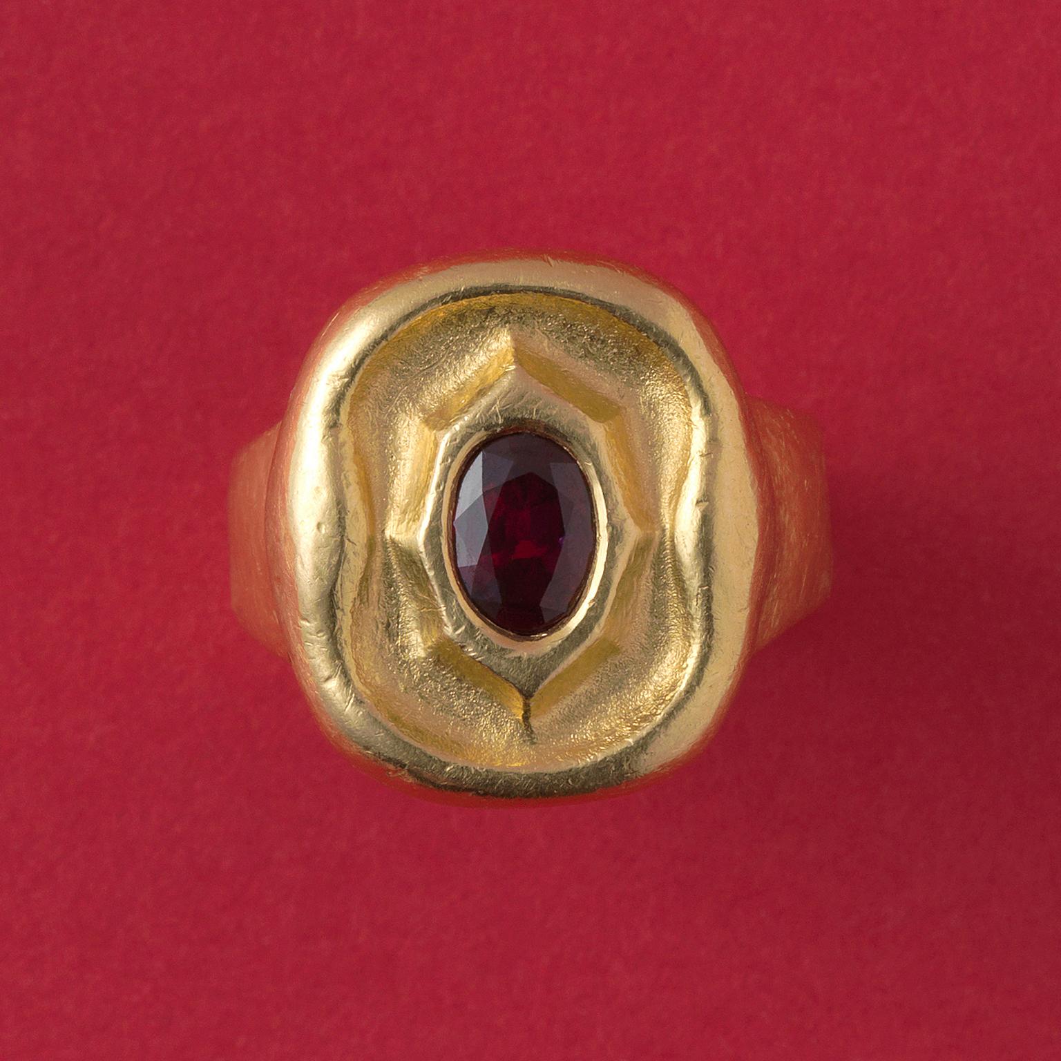 A hammered high carat gold ring set with an oval facetted natural untreated bright red Cambodian ruby (app. 1.4 carats). Rudolf Steiner; attributed Karl Mohr or his school.

ring size: 19.5 mm / 9 ½ USA
weight: 12.41 grams
dimensions: 2.0 x 1.8