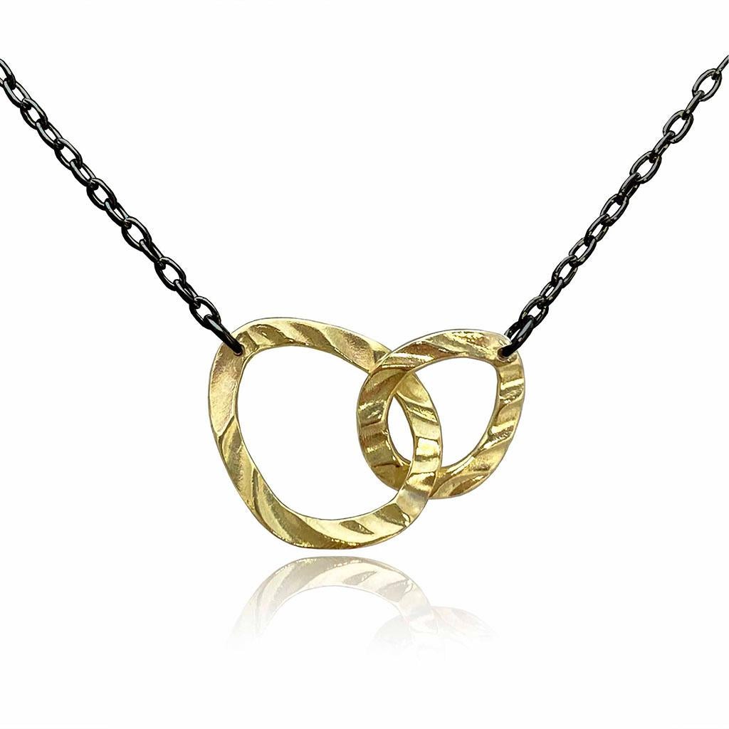 K.Mita's contemporary Harmony Necklace is handmade by the artist from two 18 Karat Yellow Gold open pebbles and a Sterling Silver chain to create a perfect sense of harmony. The pendant is 21 mm wide and 15 mm high and the chain is 16