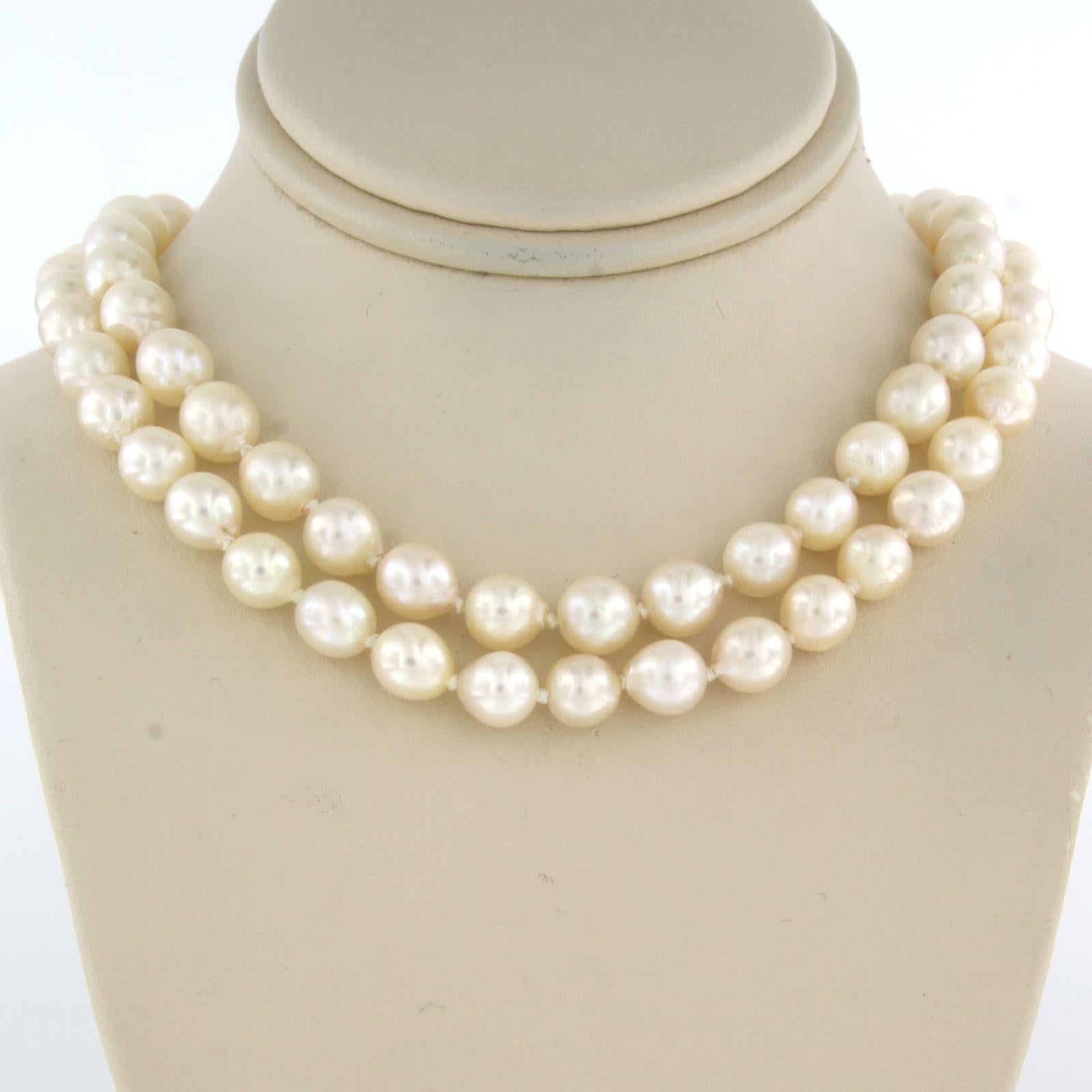 Gold and silver lock set with diamonds on a pearl bead necklace 1