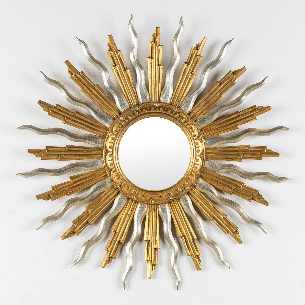 Gold and Silver mid-Century Giltwood Vintage Sunburst Mirror

Granati Bois Sculptie, C.D.V.
Brussels, Belgium; ca. 1970s
Gold and silver giltwood

Approximate size:  25.5 in. (diameter)

A beautiful giltwood sunburst mirror comprised of a series of