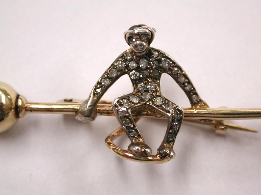 Gold And Silver Monkey Brooch Set With Diamonds, Dated Circa 1900.
Pretty novelty brooch with a silver monkey studded with old cut diamonds,
on a gold bar with gold balls at each end.
Jewellery of this period very often had the diamonds set in