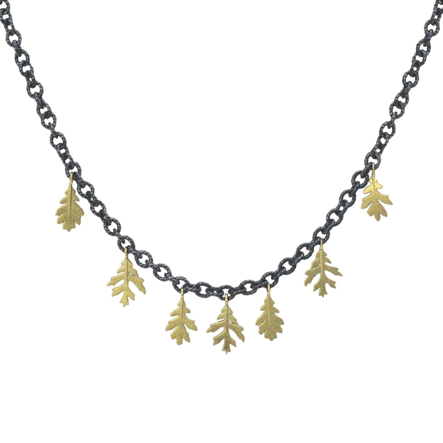 This beautifully earthy necklace brings the perfect balance of drama and delicacy, with contrasting metals and tiny gold leaves that dance along your neckline. A great piece for layering, or stunning simply on its own!

Seven oak leaves in 18k gold