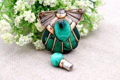 Gold and silver perfume bottle with reliefs