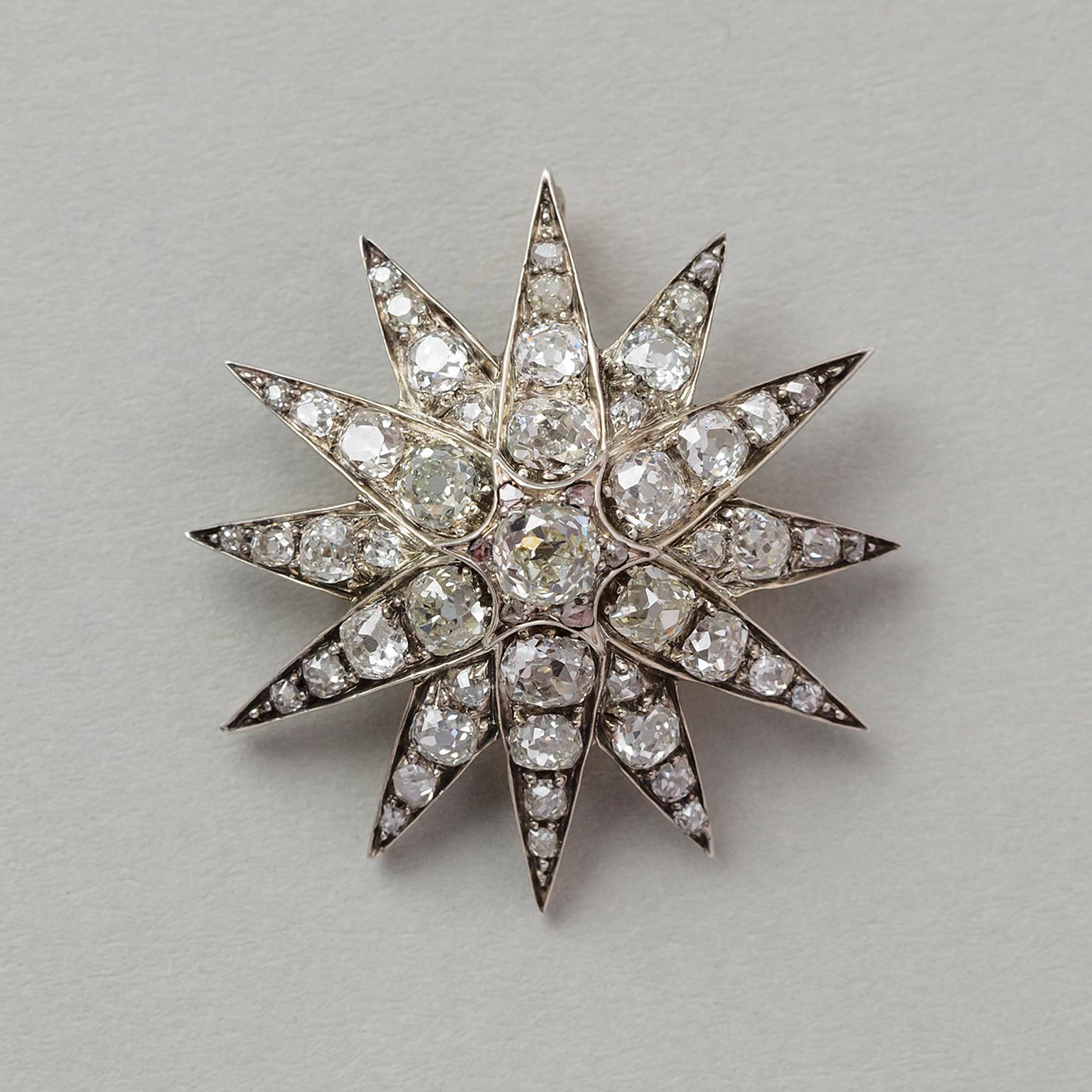 This lovely antique diamond star brooch circa 1890 is set with old cut diamonds (app. 4.5 carats) mounted in silver topped gold, and has a foldable bail so it can easily be transformed into a pendant or could once be screwed onto a tiara. Last but