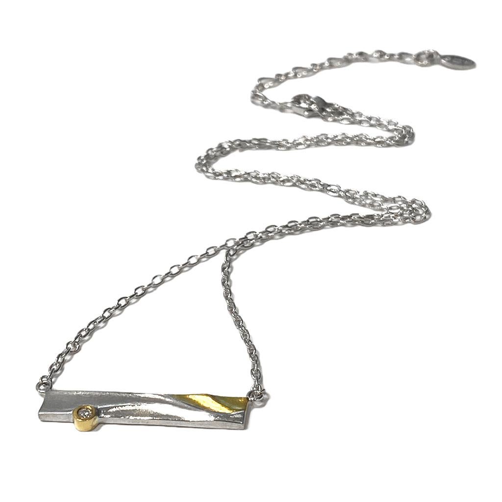 K.Mita's contemporary Zen Necklace blends 18 Karat Yellow Gold and tarnish resistant Sterling Silver to create a perfect sense of harmony. The modern necklace, which is handmde by the artist, is accented with a 0.03ct Diamond set in Sterling Silver.