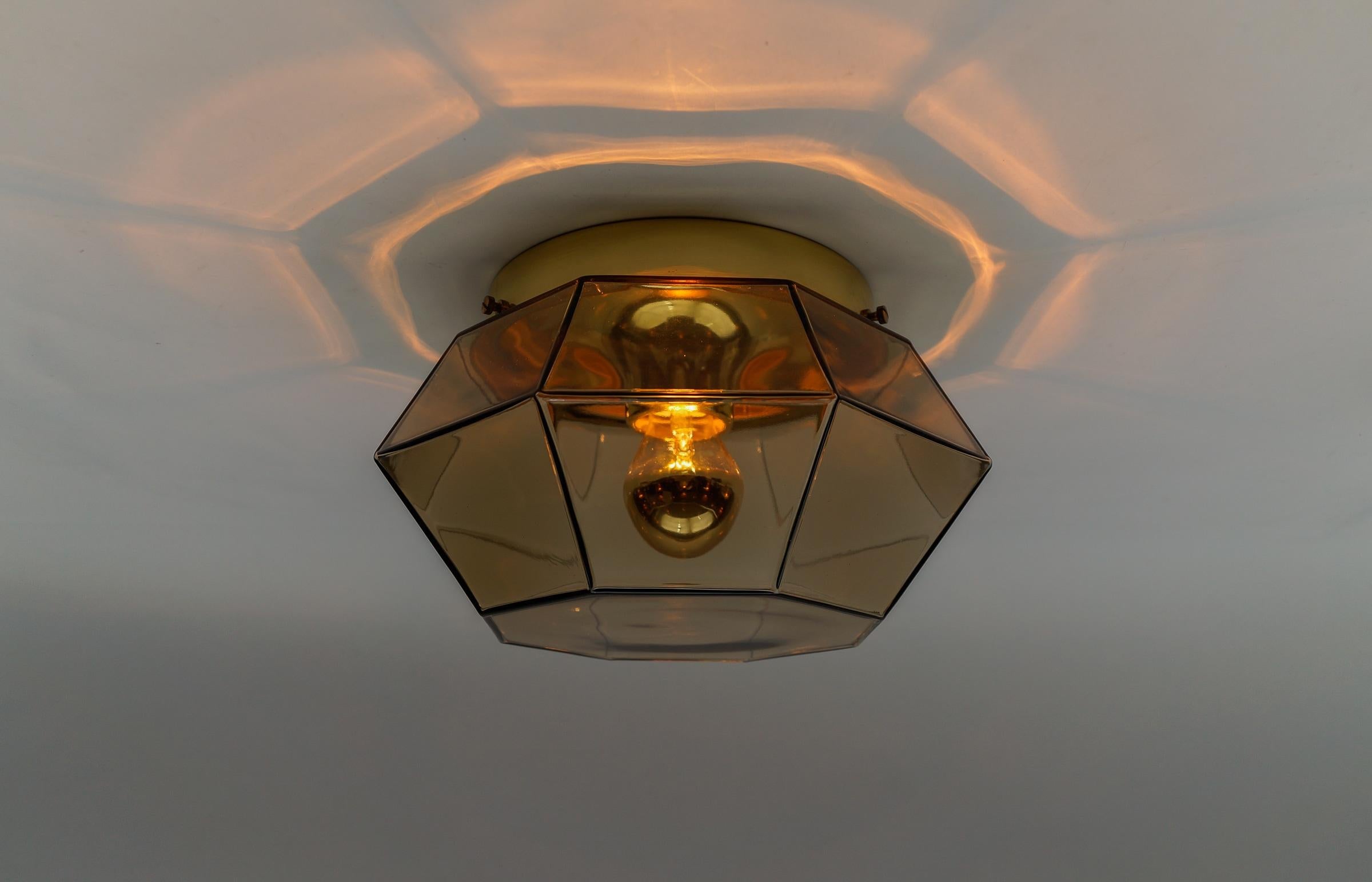Gold and Smoked Glass Flush Mount by Limburg, Germany 1960s

Octagonal shaped lantern and multifaceted clear glass.

Dimensions
Height: 7.09 in. (18 cm)
Width: 11.81 in. (30 cm)

The fixture need 1 x E27 standard bulb with 60W max.

Light bulbs are