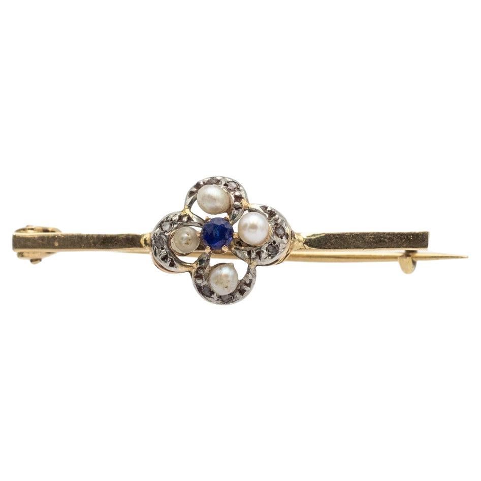 Gold antique brooch with pearls and diamonds.
