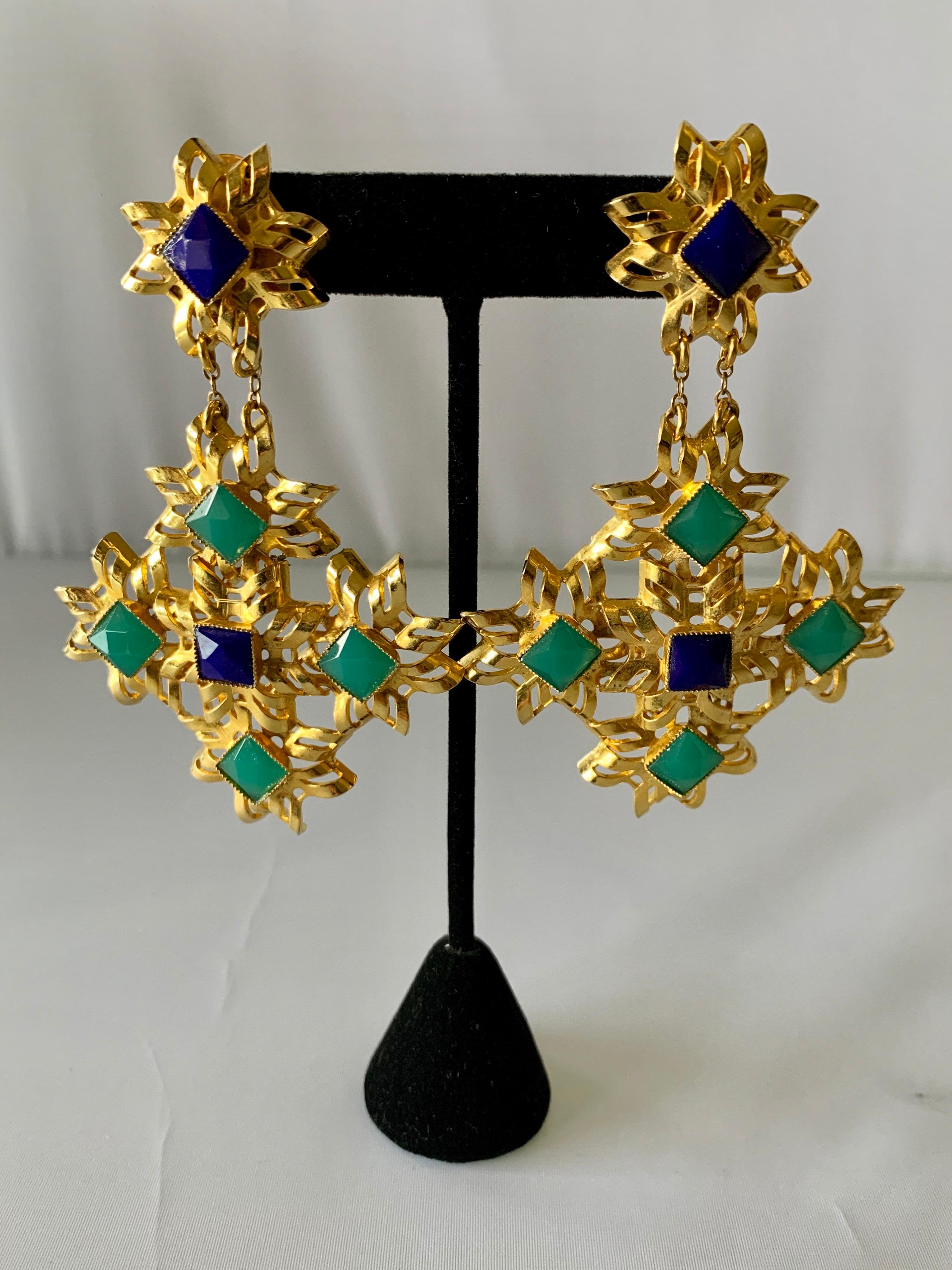 Large architectural statement clip-on earrings, comprised out of gilt metal in a contemporary open lattice motif adorned by faceted faux lapis and chrysoprase stones. The unique pair of earrings were designed by William de Lillo for American 