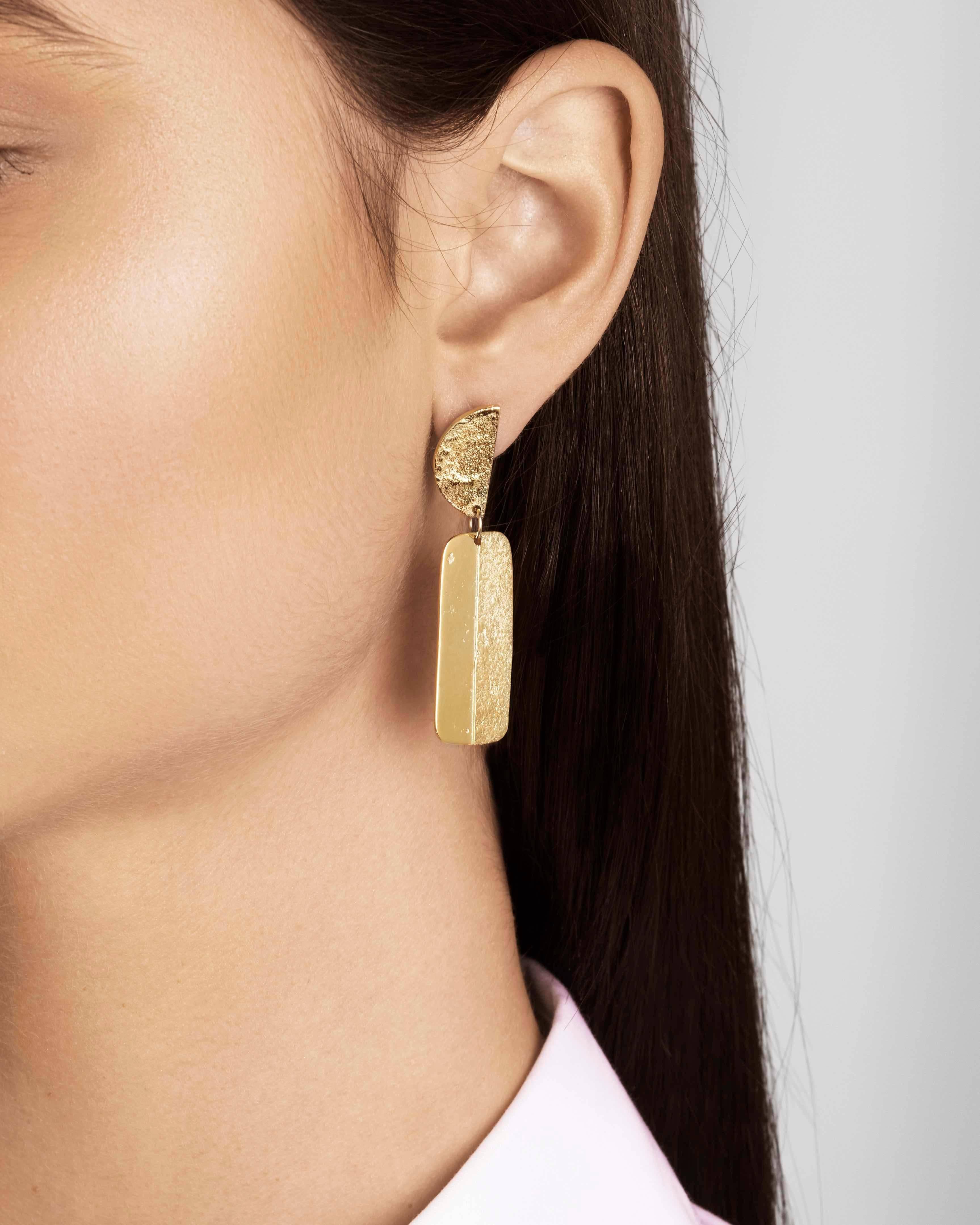 Articulated statement earrings with a combination of shimmering texture and a rustic high-polish finish. In 18-carat gold-plated sterling silver with a post and butterfly closure.  Earrings measure approximately 1.4 cm wide by 5 cm long. 

Handmade