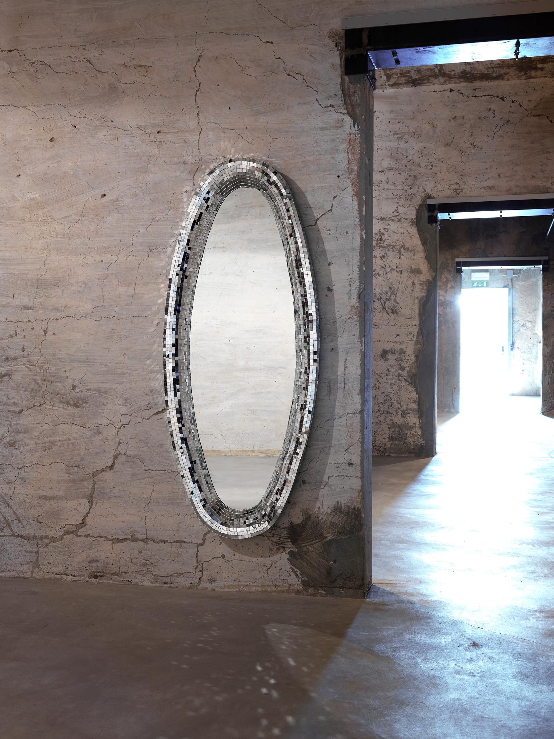 Gold Atollo mirror by Davide Medri
Materials: mirror, glass mosaic (gold)
Also available in silver.
Dimensions: H 170 x D 70 cm

Davide Medri was born in Cesena on August 7th 1967 and graduated at the Academy of Fine Arts in Ravenna, the Gino