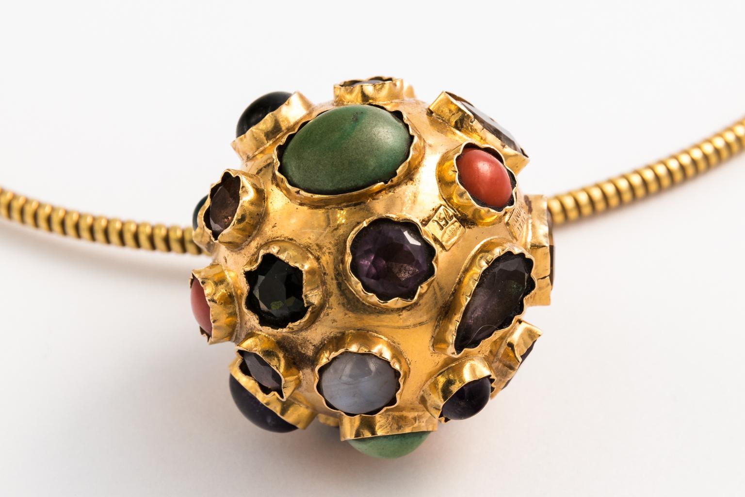 Circa 1960s 18 karat gold and gem studded charm necklace from Italy, with spring-like chain and multi-gems hand set all over the surface. Includes Turquoise, Citrine, Amethyst,Kunzite, Coral, Moonstone,and Topaz.
