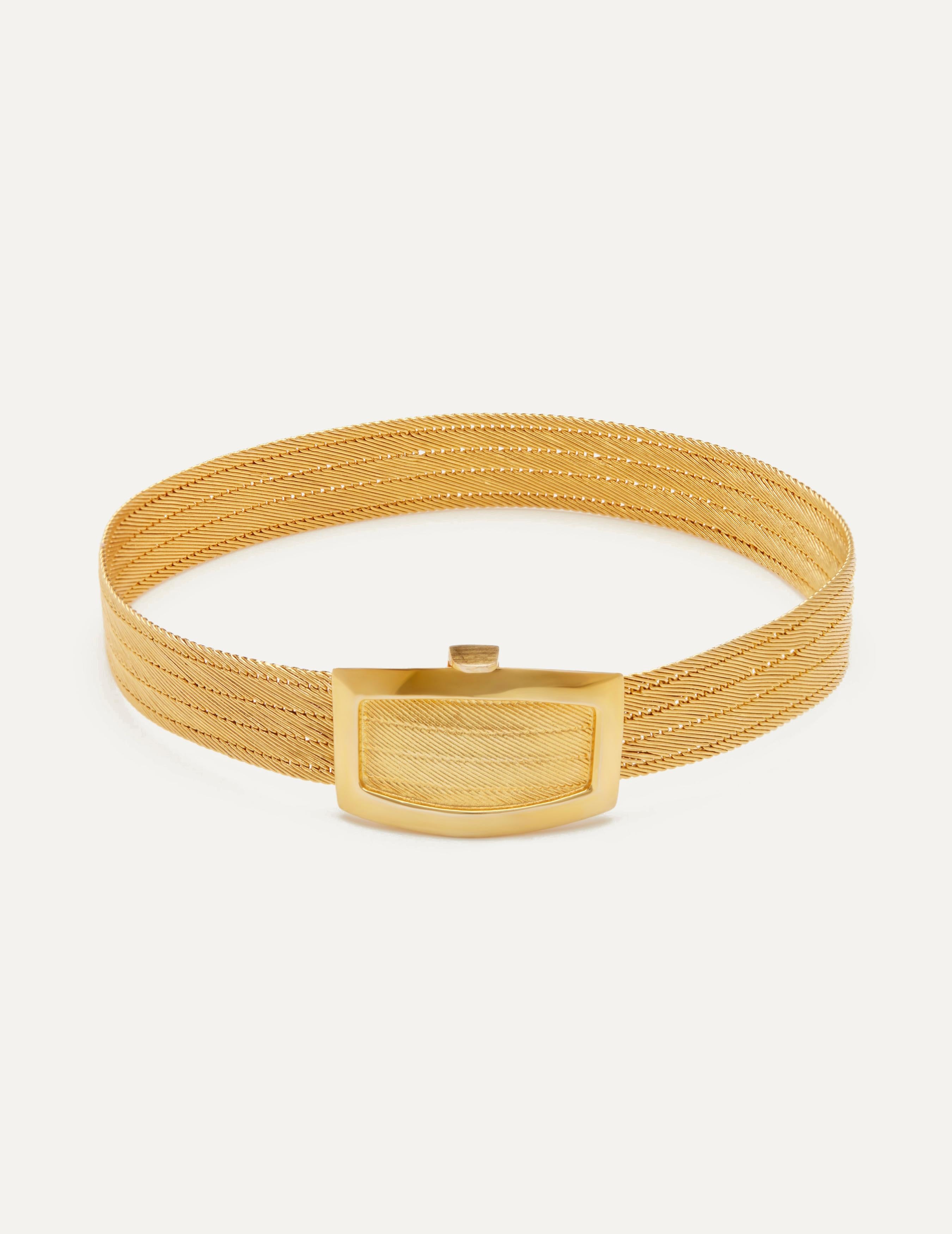 A luxurious and eye-catching jewelry piece that exudes elegance and sophistication. Crafted from lustrous 14k gold, this bracelet is designed to make a bold statement. Its substantial width adds to its commanding presence, making it a striking