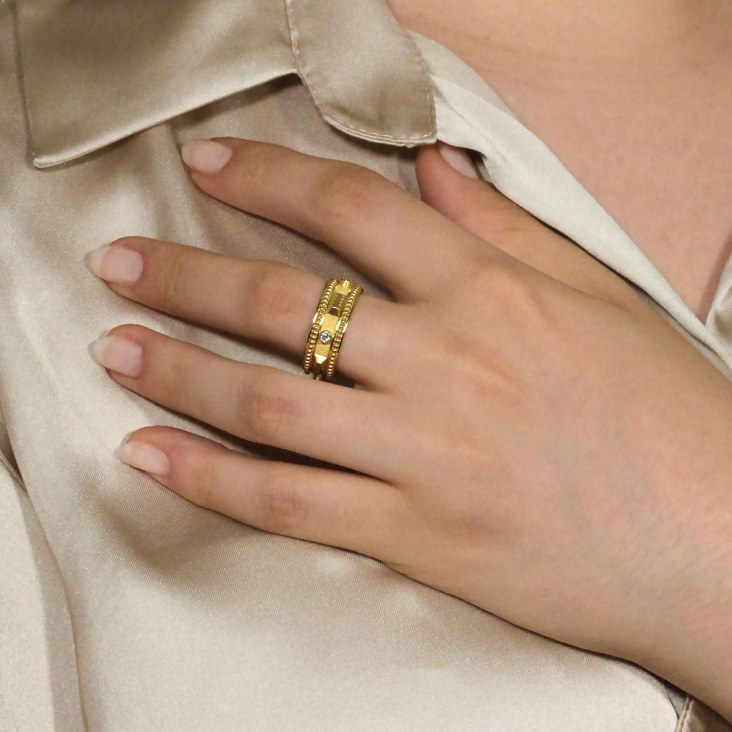 Introducing an exquisite gold band ring, designed with a captivating motif of alternating gold rectangles and sparkling diamonds. The sleek gold rectangles add a touch of modern elegance, while the radiant diamonds bring a timeless brilliance to the