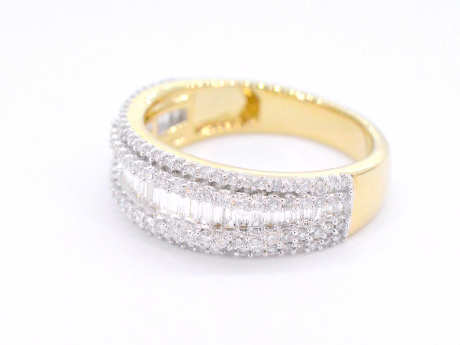 This stunning gold band ring features five rows of brilliant and baguette cut diamonds, totaling 1.00 carat. The diamonds are set in a pave setting, creating a seamless surface of dazzling gems that sparkle beautifully in the light. The band is made