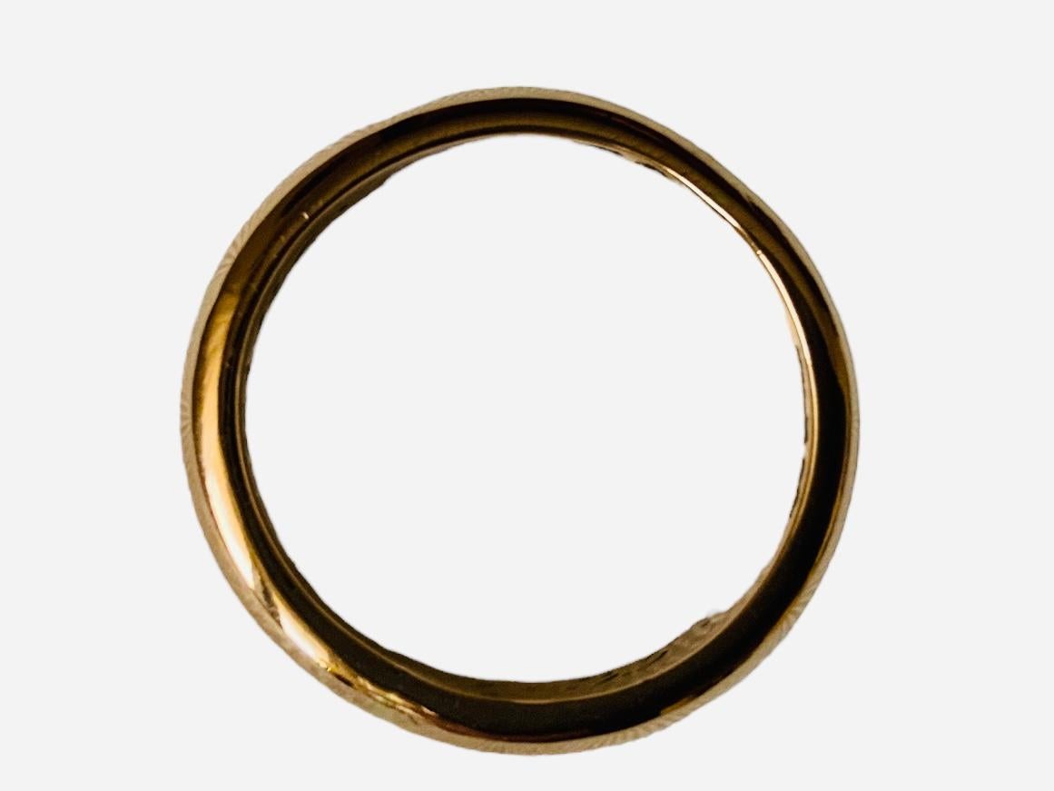 This is a Yellow Gold Band Wedding Ring. It depicts a band ring. Its weights is 5.4 grams.  Inside the ring is written Pura 7 and 35.
