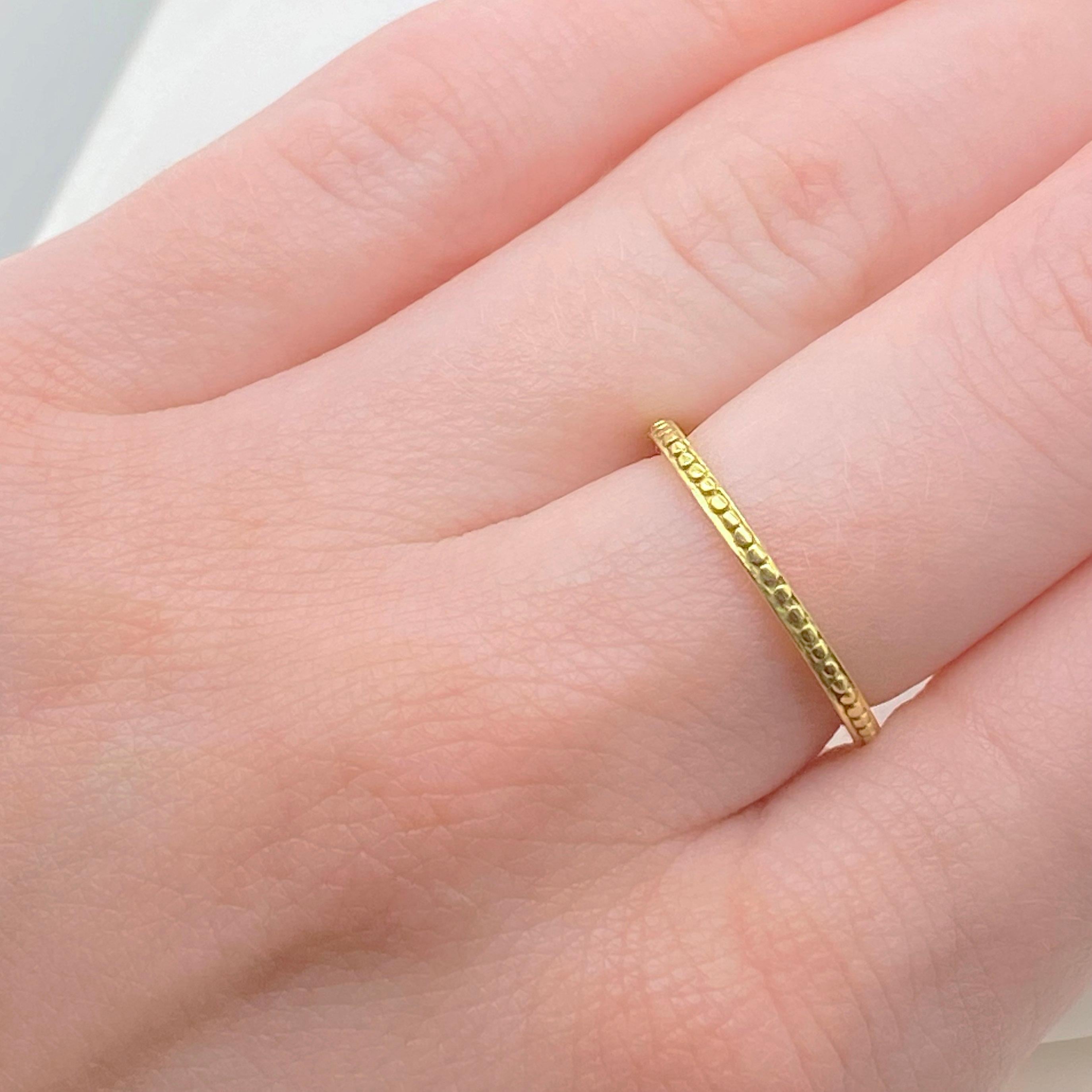 This is a gorgeous and slender 18K yellow gold band with beaded details, perfect as a minimalist wedding ring, or stacking ring. The details for this beautiful ring are listed below:
Metal Quality: 18k Yellow Gold
Band Width: 1.7 millimeters
Ring