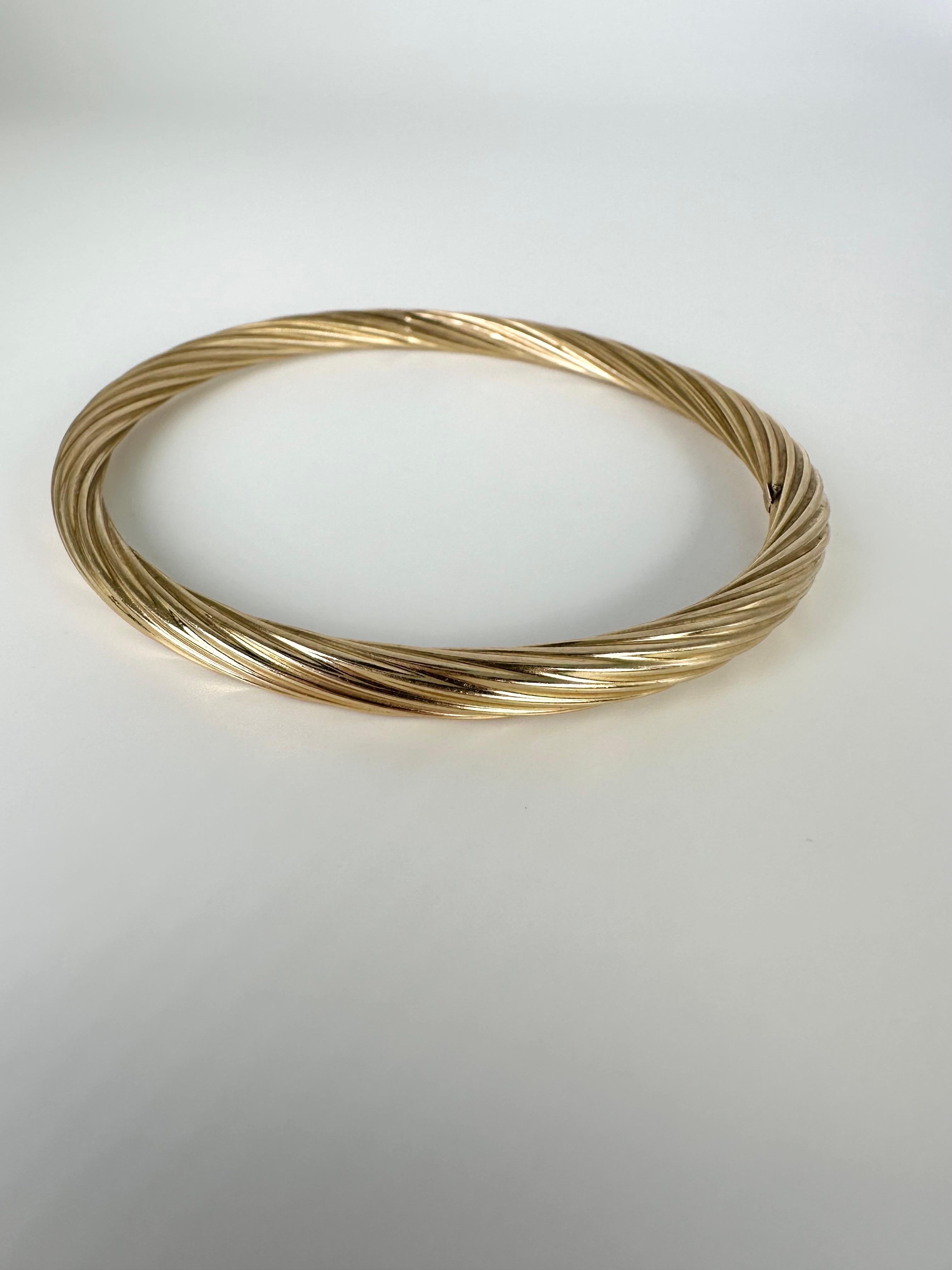 Unique twisted style halow bangle in 14KT yellow gold. Simple to slide on with approximately 7cm diameter and 5mm width of the bangle.

GOLD: 14KT gold
Grams: 8.10
Item#: 440-00044KTT

WHAT YOU GET AT STAMPAR JEWELERS:
Stampar Jewelers, located in