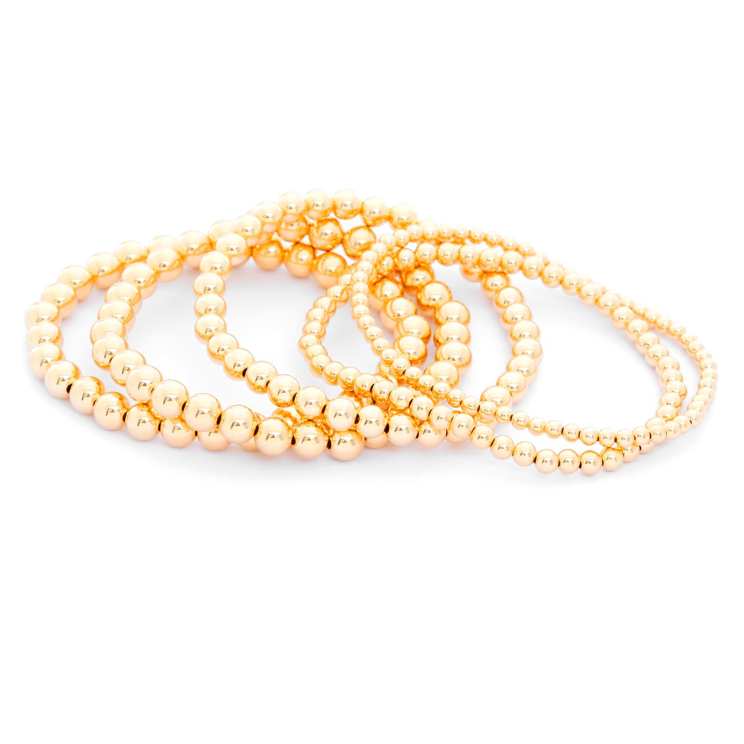 Gold Bead Ball Stretch Bracelets - Five stack-able bead bracelet. Pictured  one 3 mm, one 4 mm, one 5mm, two 6mm.  New with DeMesy pouch. Wearable all day and in the shower and they will still hold their luster and stretch.