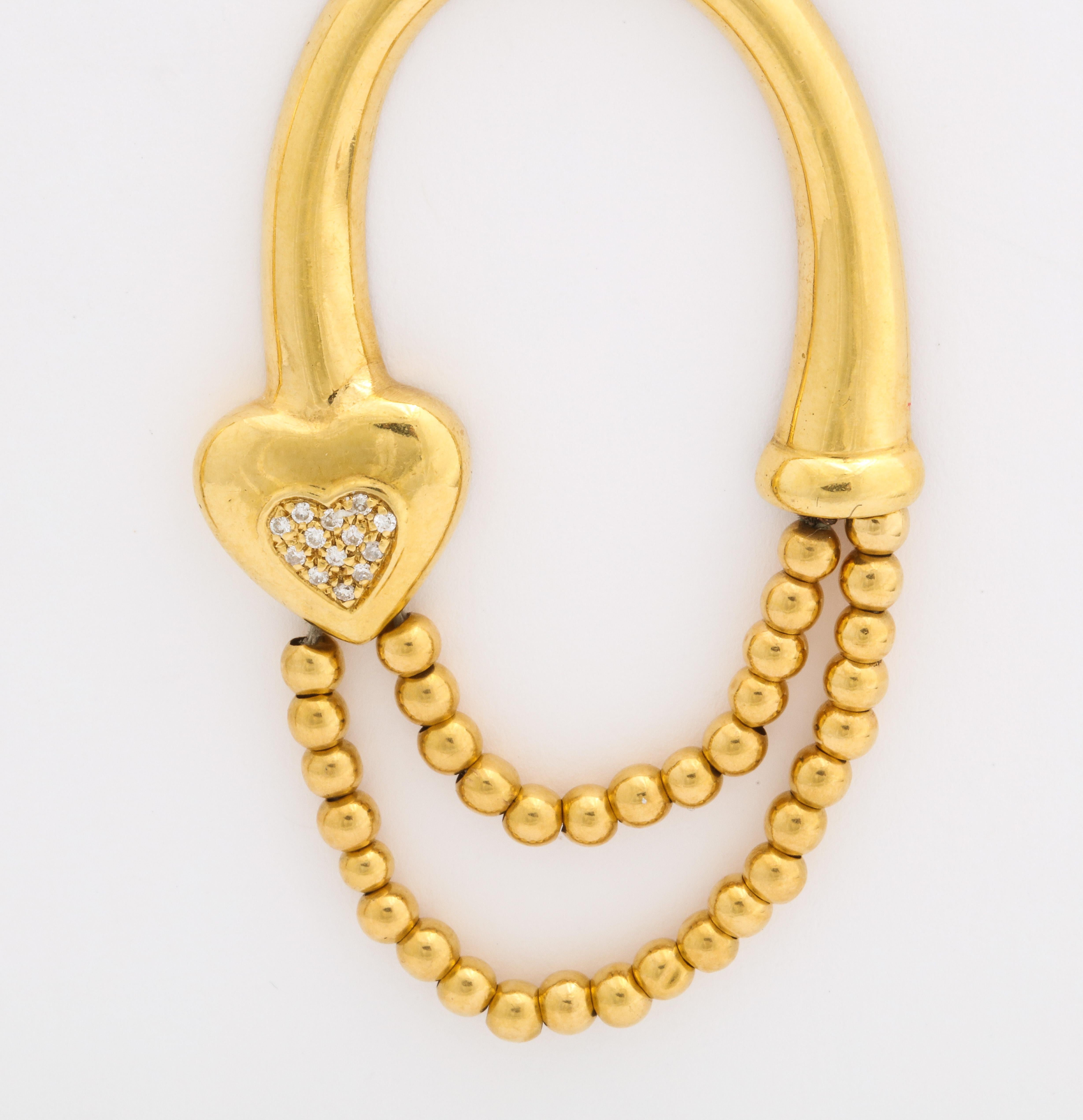 A Highly Styled pair of 18k Gold Bead Hoop Earrings with Diamond Hearts.   There are small diamonds the heart as well as the ear post.  
These 18 K earrings have a very contemporary look and are day wearable.They can be both fun and serious.