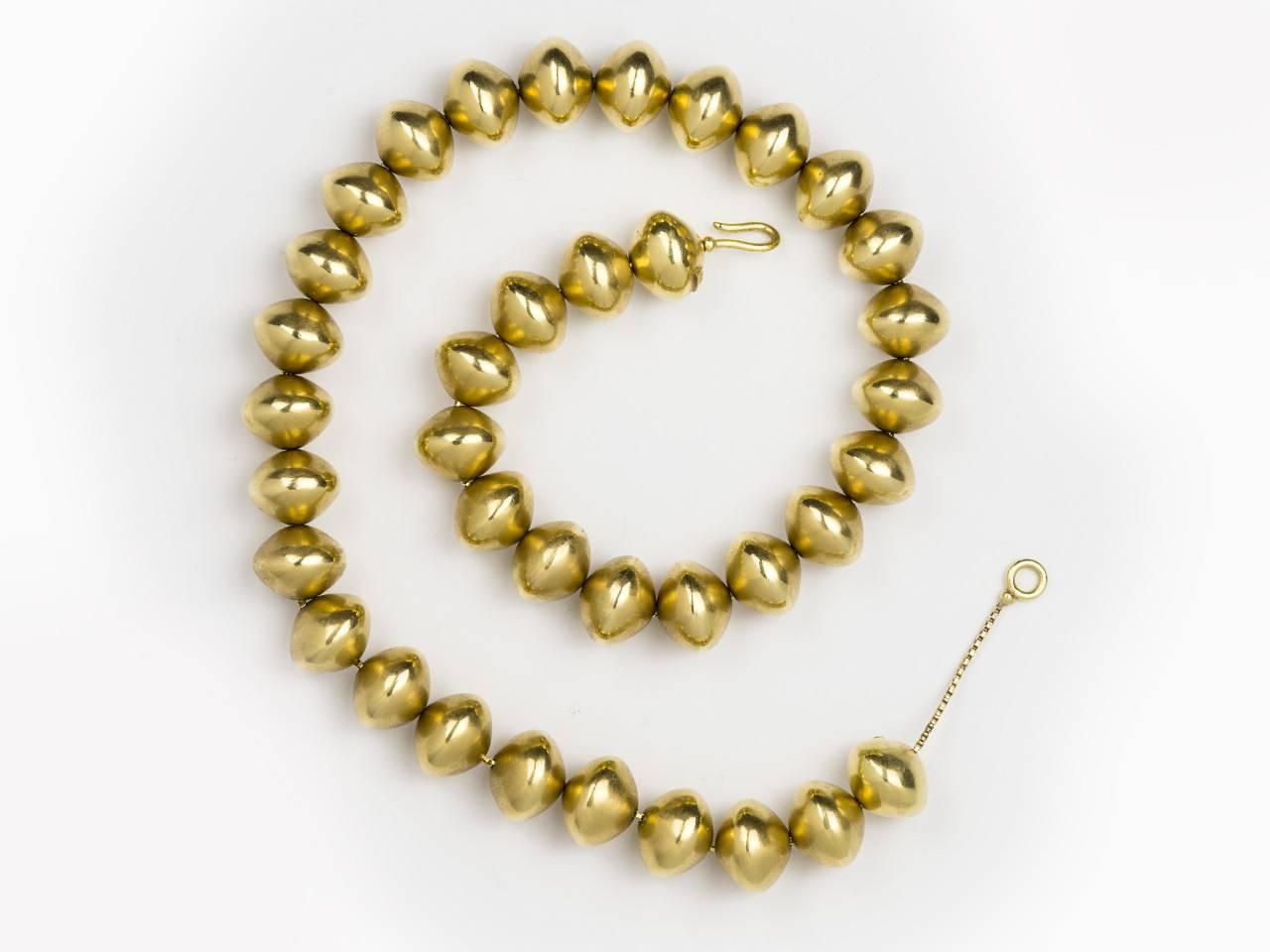 18kt gold bead necklace on a traveling chain. Signed, 1999 , 750, and 18k. 