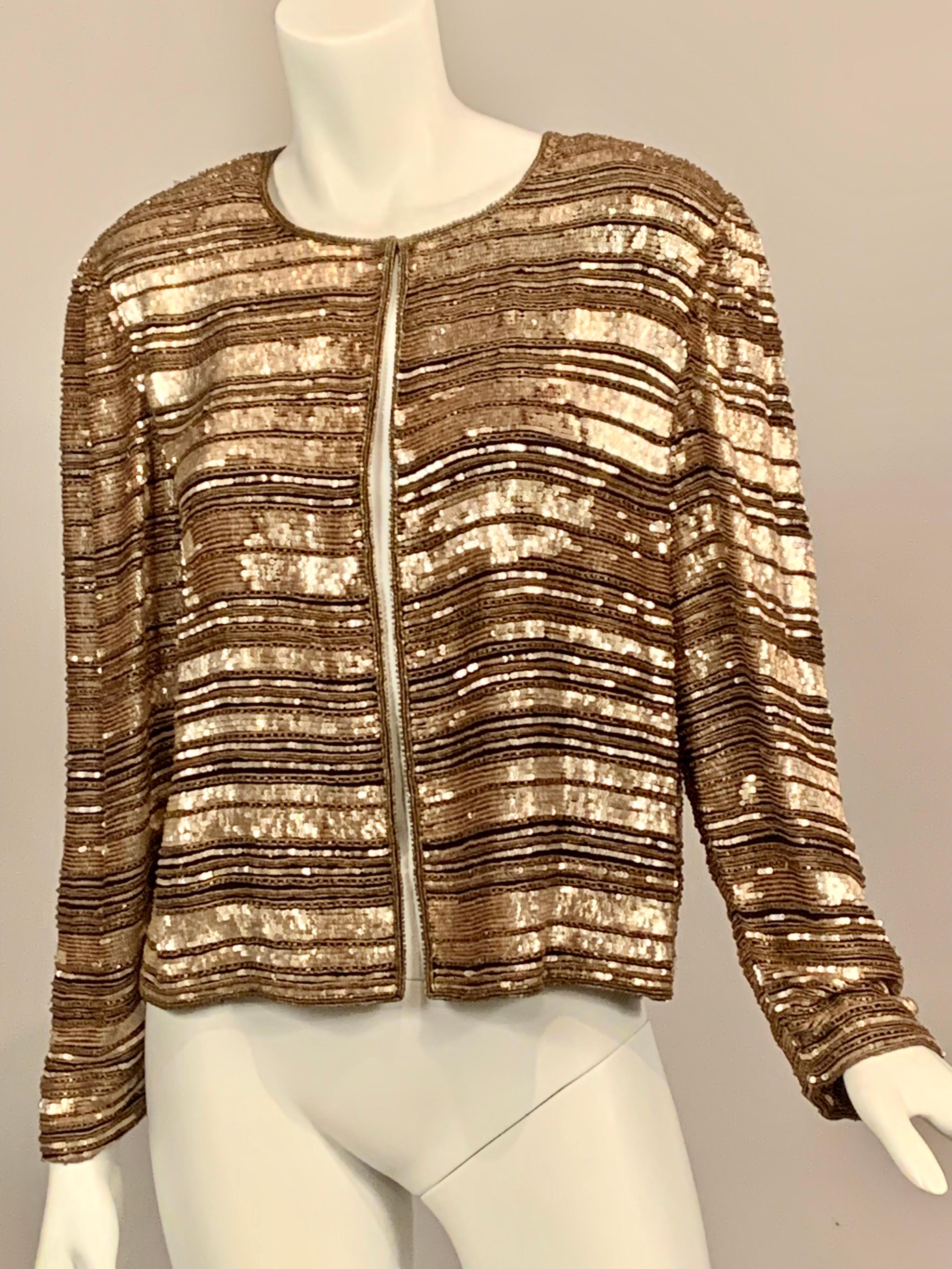 Reminiscent of many jackets designed by Coco Chanel, this jacket is a classic cardigan style with a single hook and eye at the neckline for closure.  It is all about the embellishment!  All of the sequins, bugle beads and caviar beads  are very,
