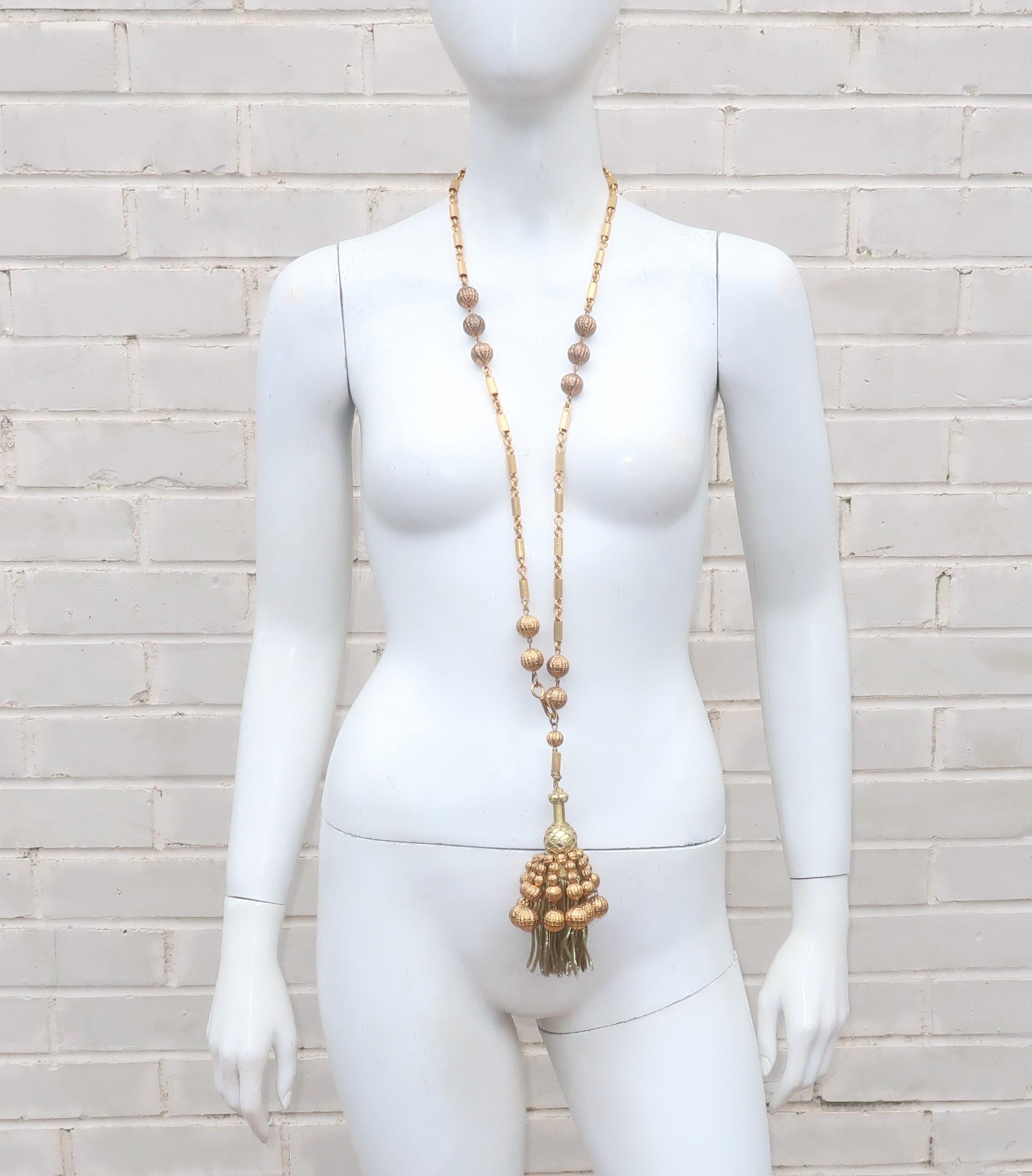 A great 1960’s gold beaded tassel and chain that can do double duty as an opera length statement necklace or a swag belt with a quick change of the hook.  A fun swinging sixties look that has an Art Deco revival style perfect for accessorizing a