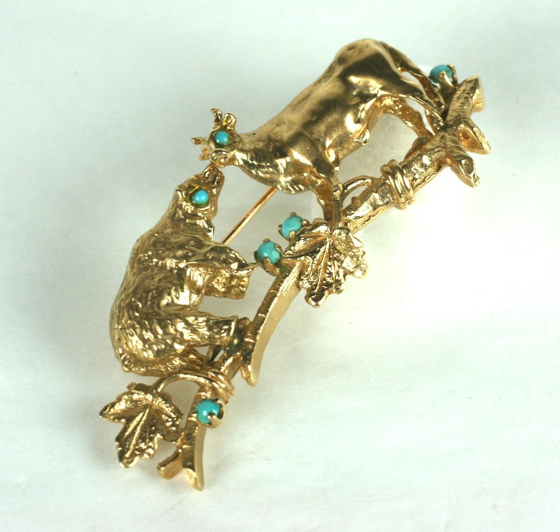 Bear and Bull brooch in heavy cast 14k gold set with turquoise cabochons. The bear appears to be kissing the bull but there is actually a space between them and the bear appears to be sharing a secret from the back. 
2