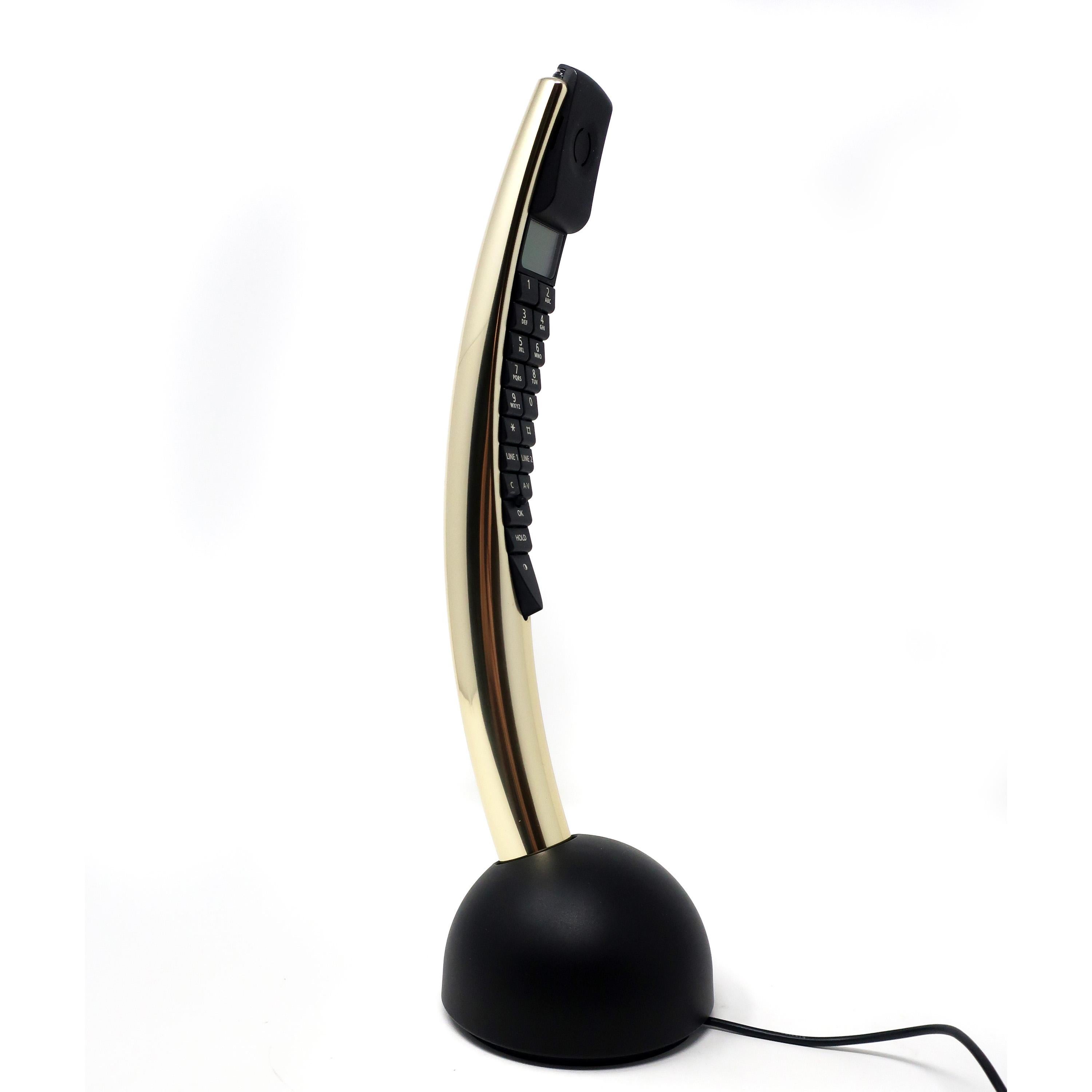 Designed by David Lewis with a curved aluminum body to fit naturally in the user’s hand, B&O’s BeoCom2 cordless telephone was released in March 2002 in a range of colors and finishes. This highly collectible phone is in the shiny gold finish and