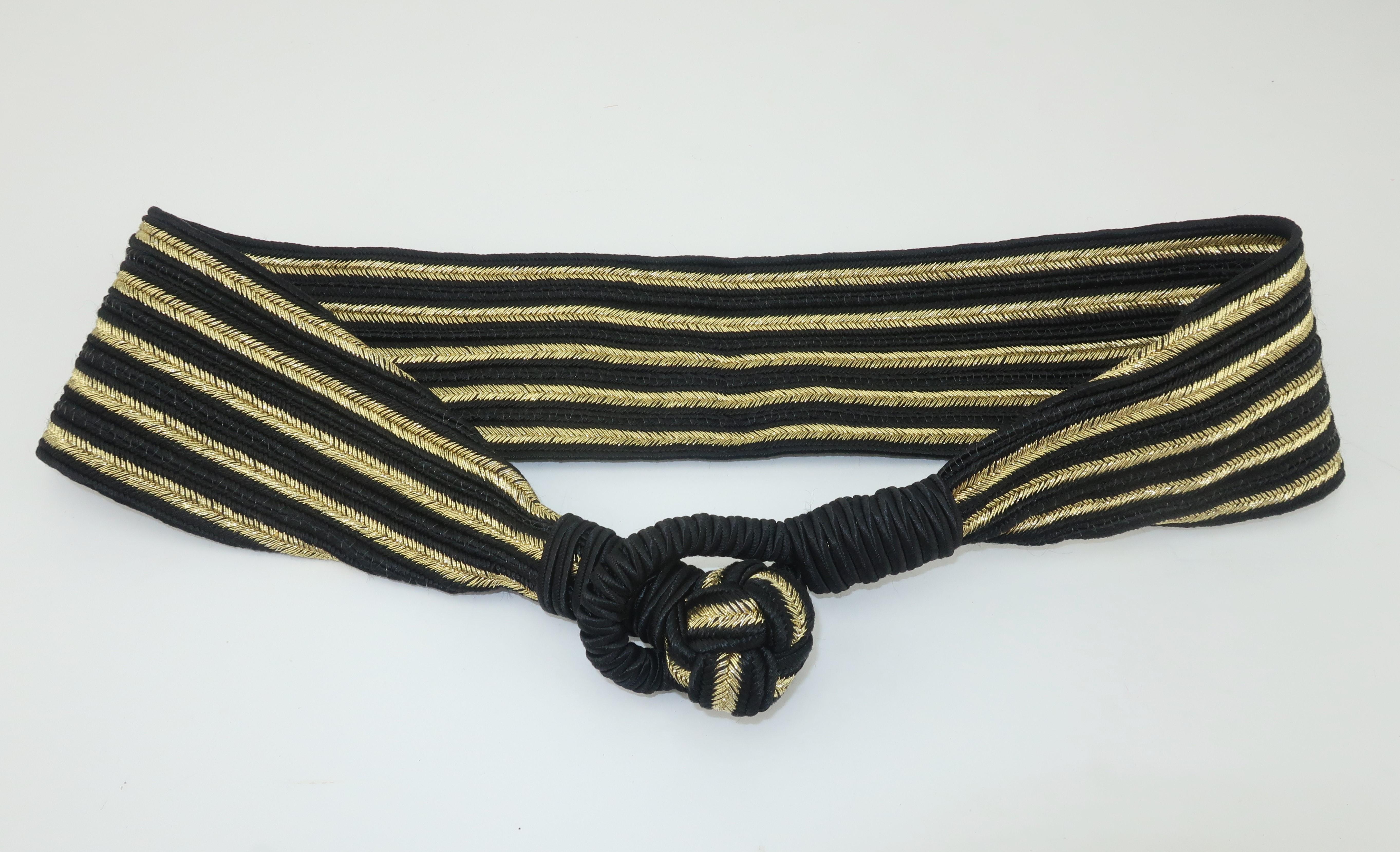 Cinch it in style with this black silk corded cummerbund belt with metallic gold stripes.  The frog closure adds a touch of the exotic making it a perfect pairing for vintage styles ranging from art deco inspirations of the 1930's to disco fashions