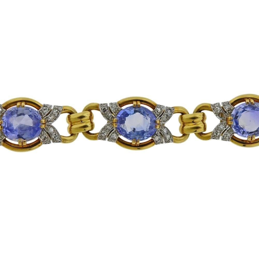 18k yellow gold bracelet, featuring 6 oval faceted blue gemstones- each stone measures approx. 10 x 8.3 x 5.8mm.  Diamonds approx. 0.70ctw. Bracelet is 7.25