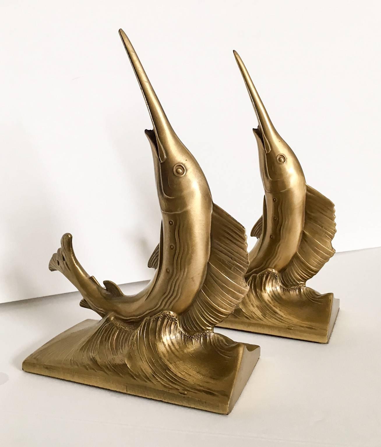 Heavy pair of gold-finish spelter bookends in the form of a dolphin on a wave. Beautifully detailed and can be used for bookends in position 1 or 2 as photographed. Unmarked.