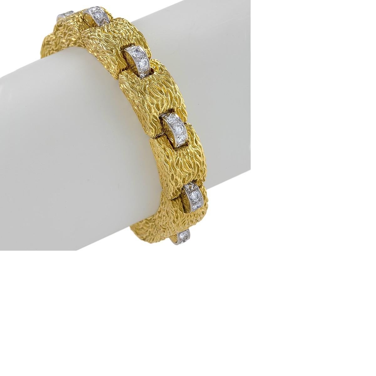 An 18 karat gold bracelet with diamond by David Webb. The bracelet has a 50 round platinum set diamonds with a G-H-VS clarity with an approximate total weight of 5.00 carats. The bracelet is composed of rectangular bombé links hammered in a wavy