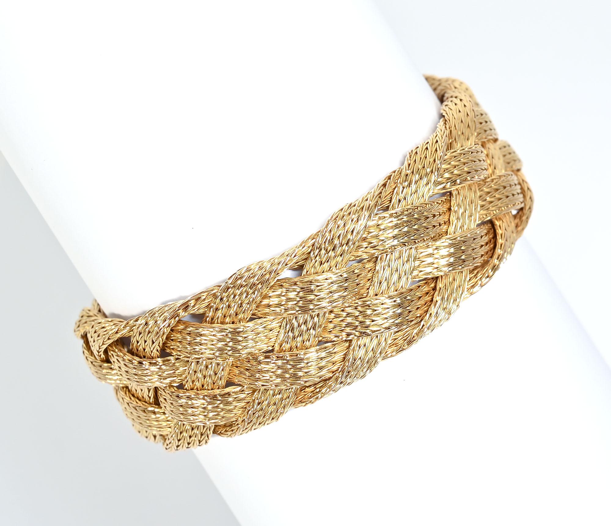 Exquisitely made 18 karat braided bracelet. There are four woven strands, each of which is made of very finely made woven V's. Only with magnification does one realize the delicacy of weaving for each strand.
The bracelet is 7/8