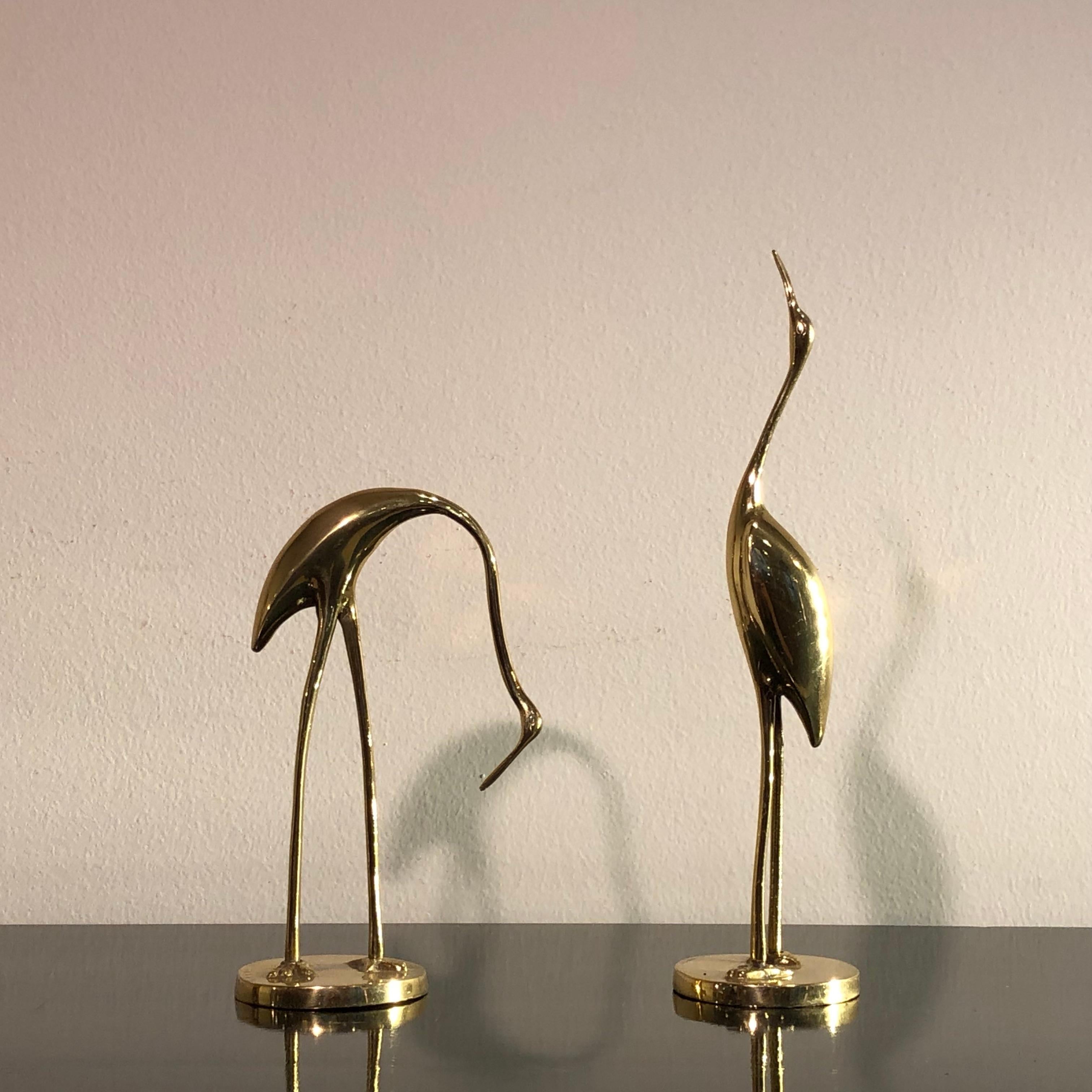 Gold brass little herons form France from 1970s. Rounded base, original patina not restored. Ideal for a charming Christmas or Wedding present. Size: high 30 cm and 21 cm, base 8 cm diameter.