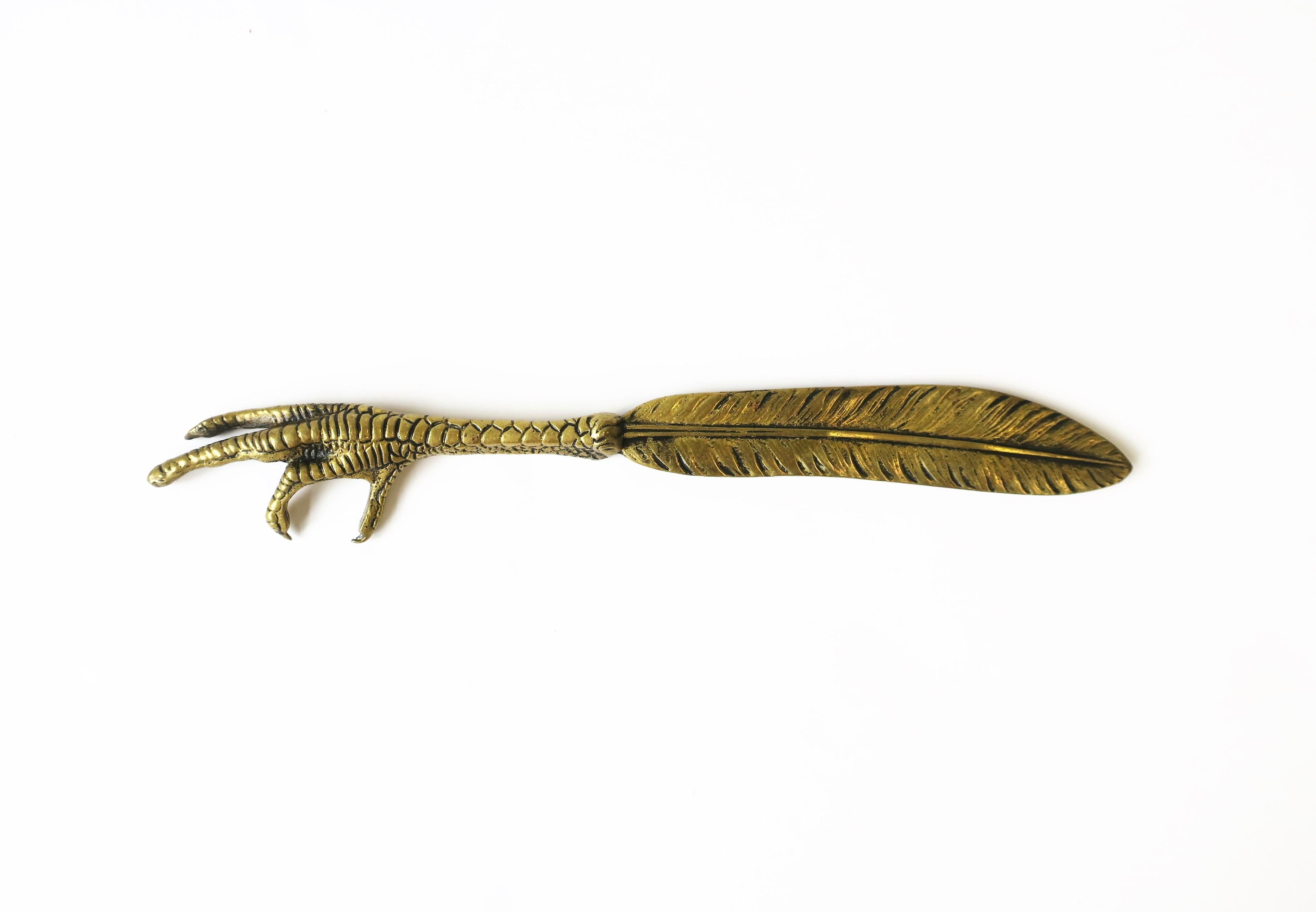 A gold brass bird claw and feather letter opener. A great desk accessory. Dimensions: 1.5