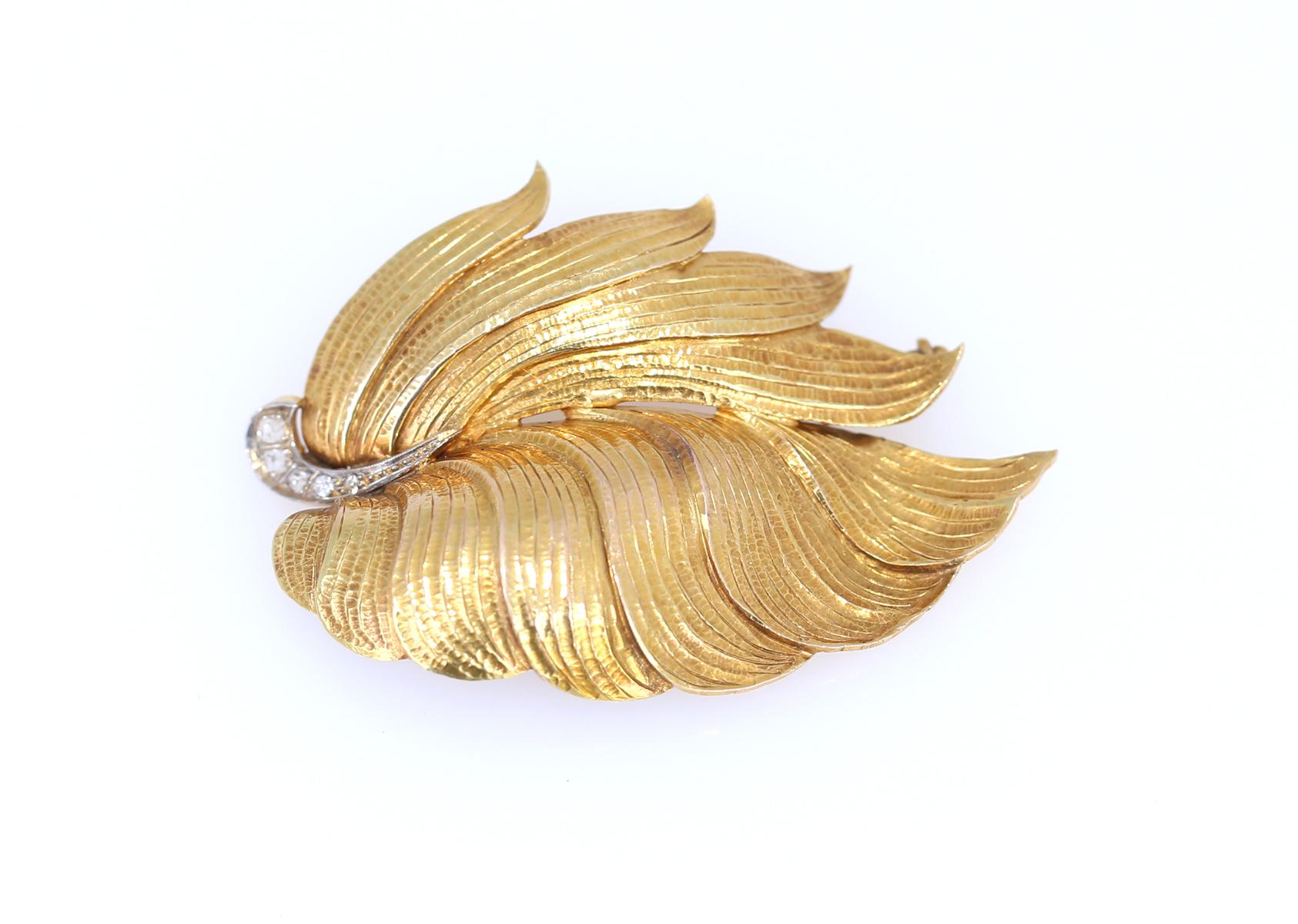 Fine brooch with natural ornament leaves on the wind. Set with small diamonds. The jeweler craft is just outstanding, the gold really mimics the natural leave so perfectly.

Once it was common to communicate a message via pin or brooch. Nowadays