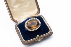 Gold brooch with citrine and natural pearls, early 20th century.