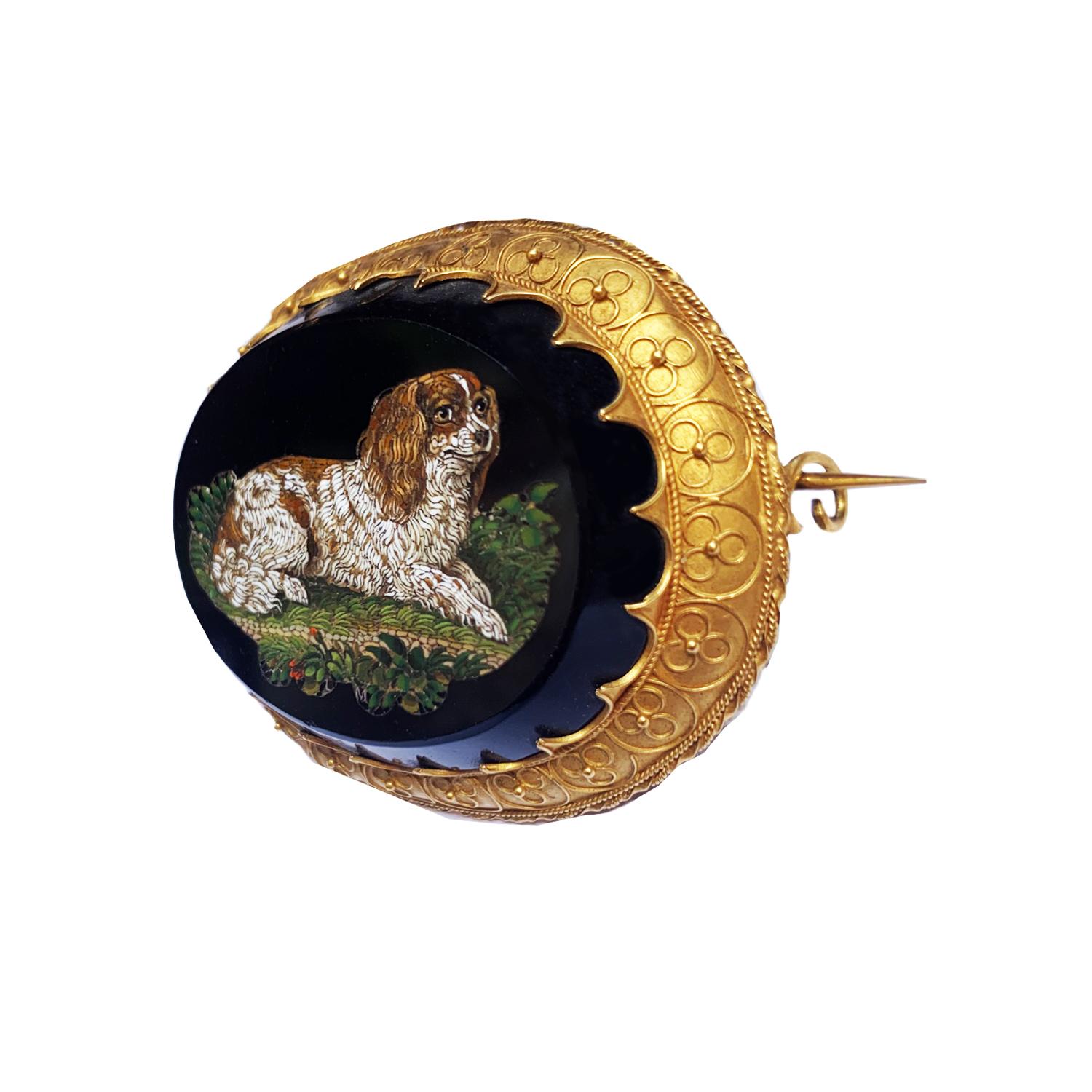 This Gold and Micromosaic brooch was made by Luigi Moglia, famous micromosaics of the Vatican Mosaic Studio -circa 1840, and depict a little dog.
In the grass under the dog, there is Moglia's signature, LM

The Museo Borgogna in Vercelli has a