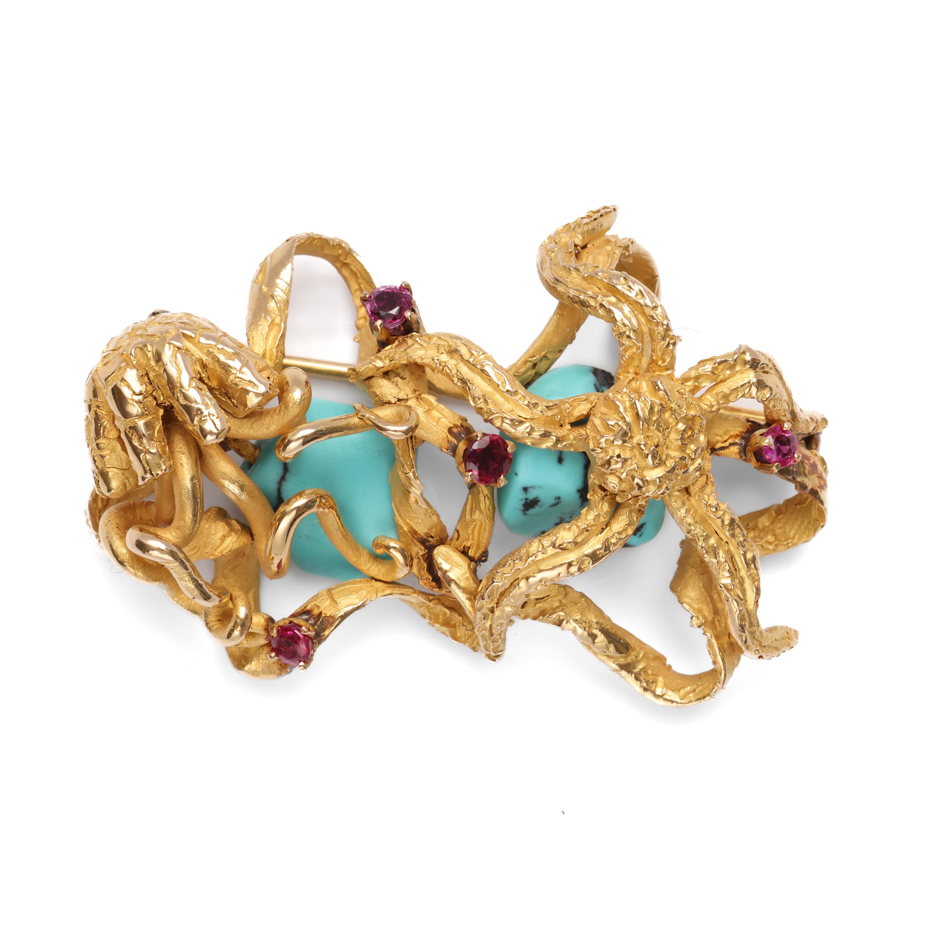A jellyfish and a starfish appear engaged in battle over two gorgeous blue turquoise stones. High-quality natural rubies cling to the pair. This brooch came to me from an estate of pristine jewels from Argentina. Like the other pieces, there appears