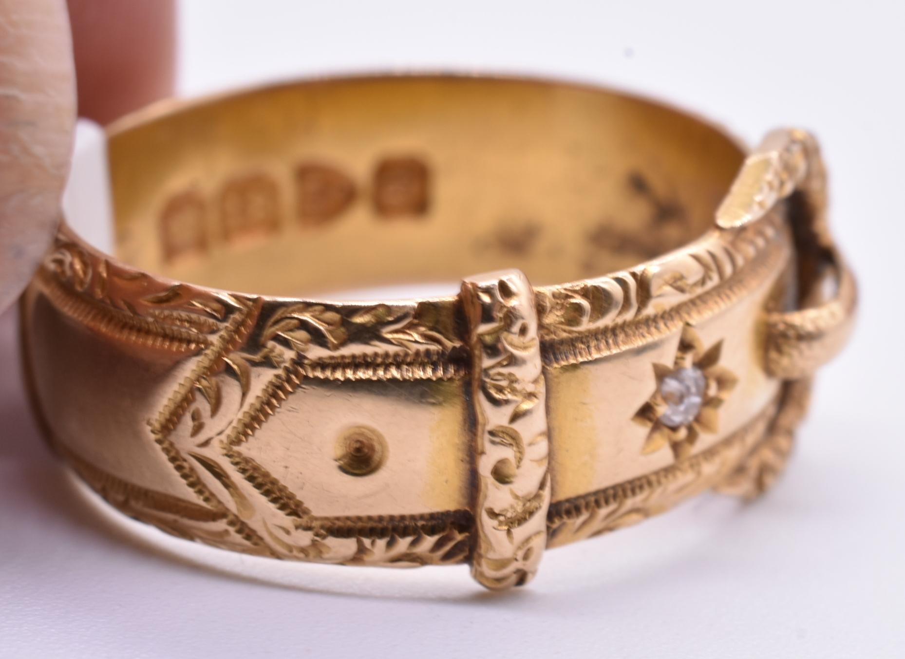 18K gold buckle ring with an etched pointed star which houses a diamond and an ornate border, hallmarked 1899 Chester. Victorian Diamond Buckle Ring.  Buckle imagery was used in the Victorian and Edwardian eras to symbolize fidelity, and eternal