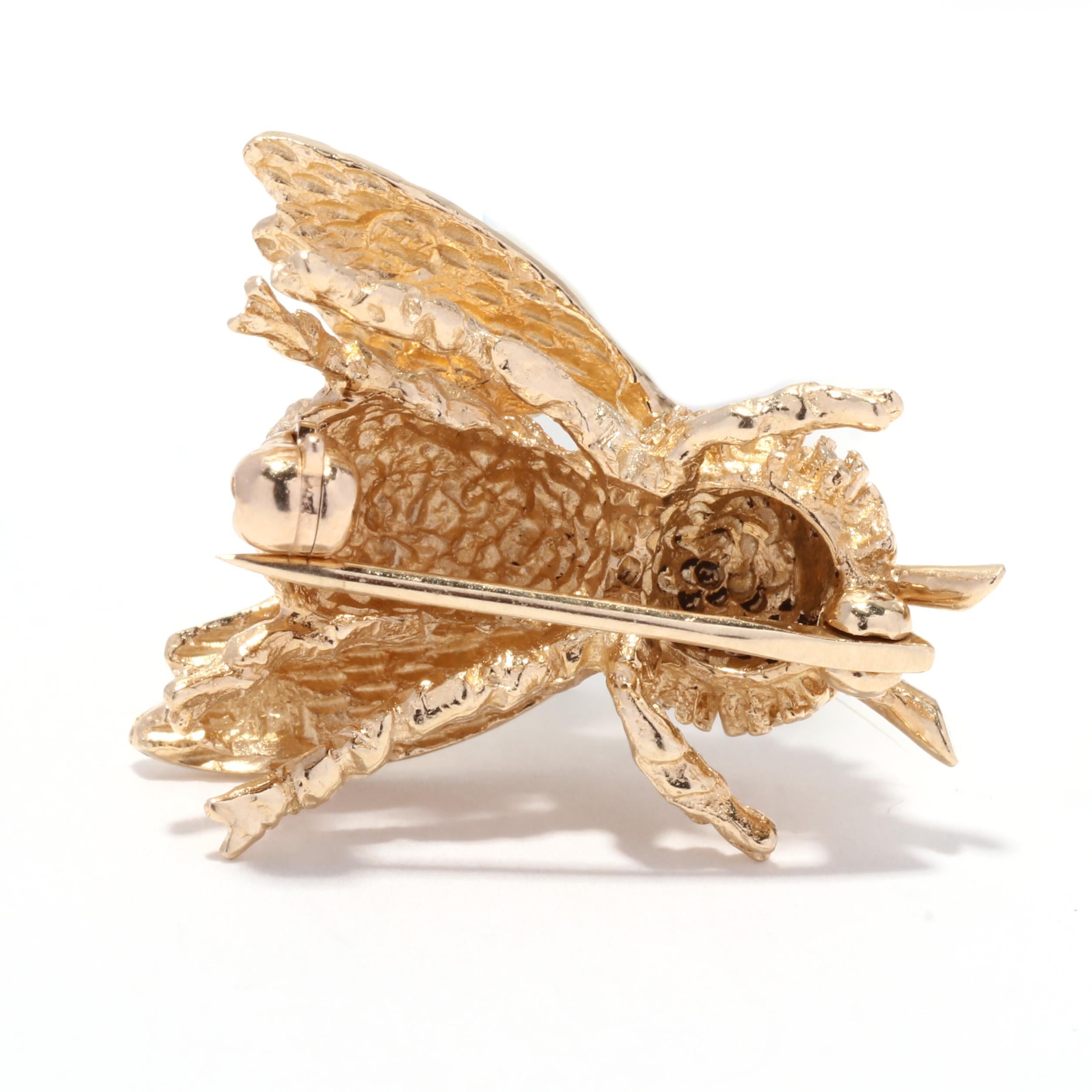 A vintage 14 karat yellow gold bumble bee brooch. This small gold brooch features a bumble bee motif with stippled and textured detailing, with a pin stem clasp.

Length: 3/4 in.

Width: 5/8 in.

Weight: 2.9 dwts. / 4.5 grams

Metal: 14KT