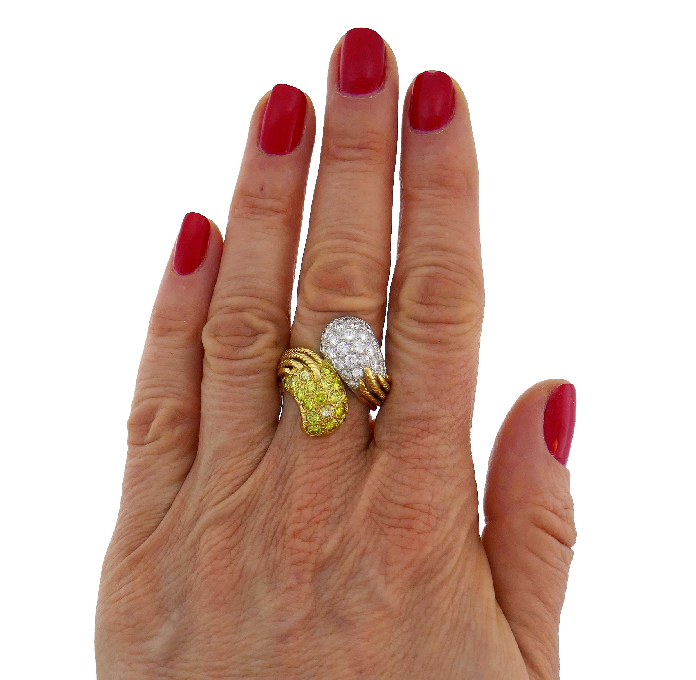 Classy and timeless bypass style cocktail ring.
The ring is made of  18 karat yellow gold and platinum and set with twenty-seven white and nineteen fancy yellow round brilliant cut diamonds. White diamonds total weight is approximately 1.76 carats,