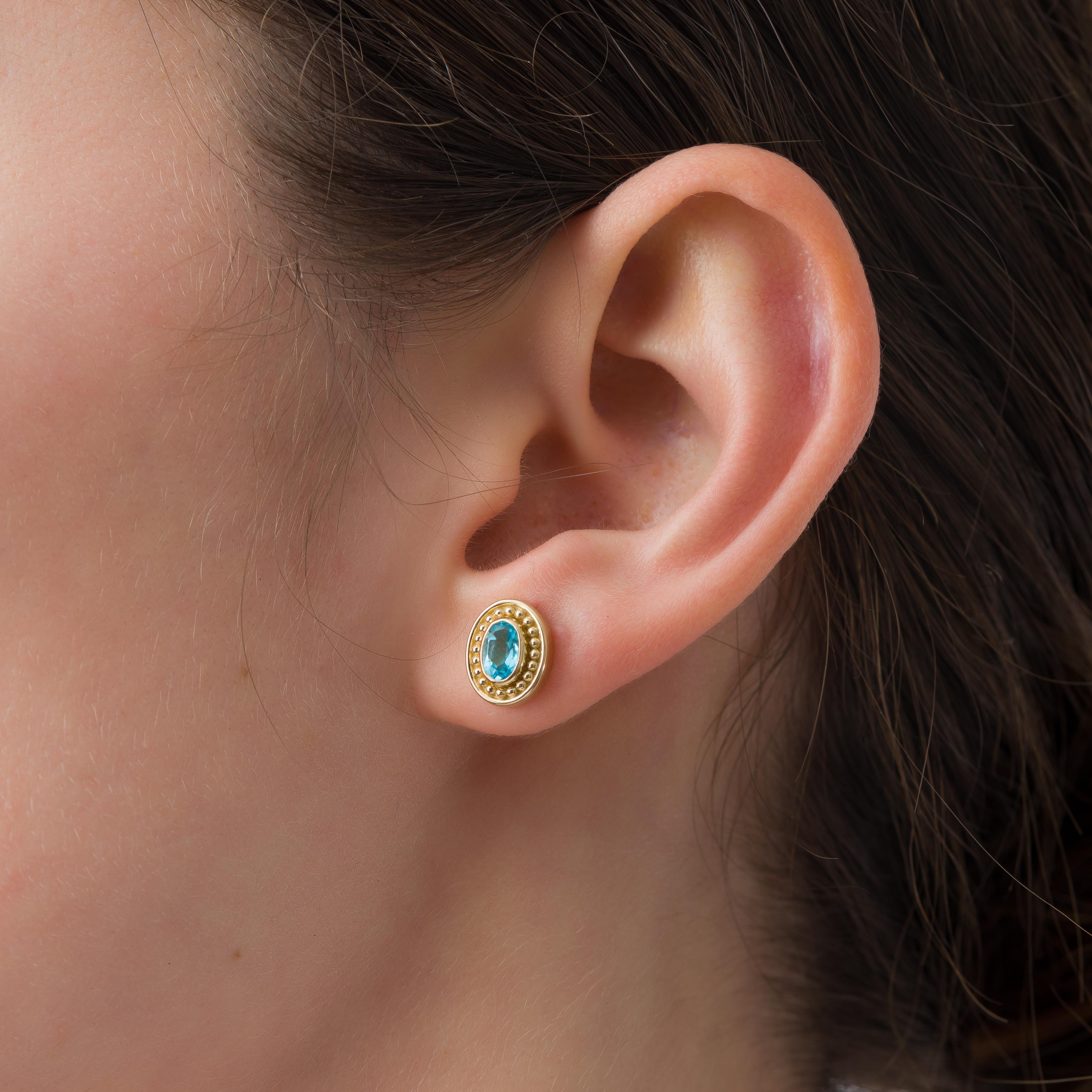 Adorn your ears with our gold earrings, featuring an oval Swiss topaz, inspired by the grandeur of the Byzantine era—a testament to enduring beauty and classic craftsmanship.

100% handmade in our workshop.

Metal: 18K Gold
Gemstones: Swiss Blue