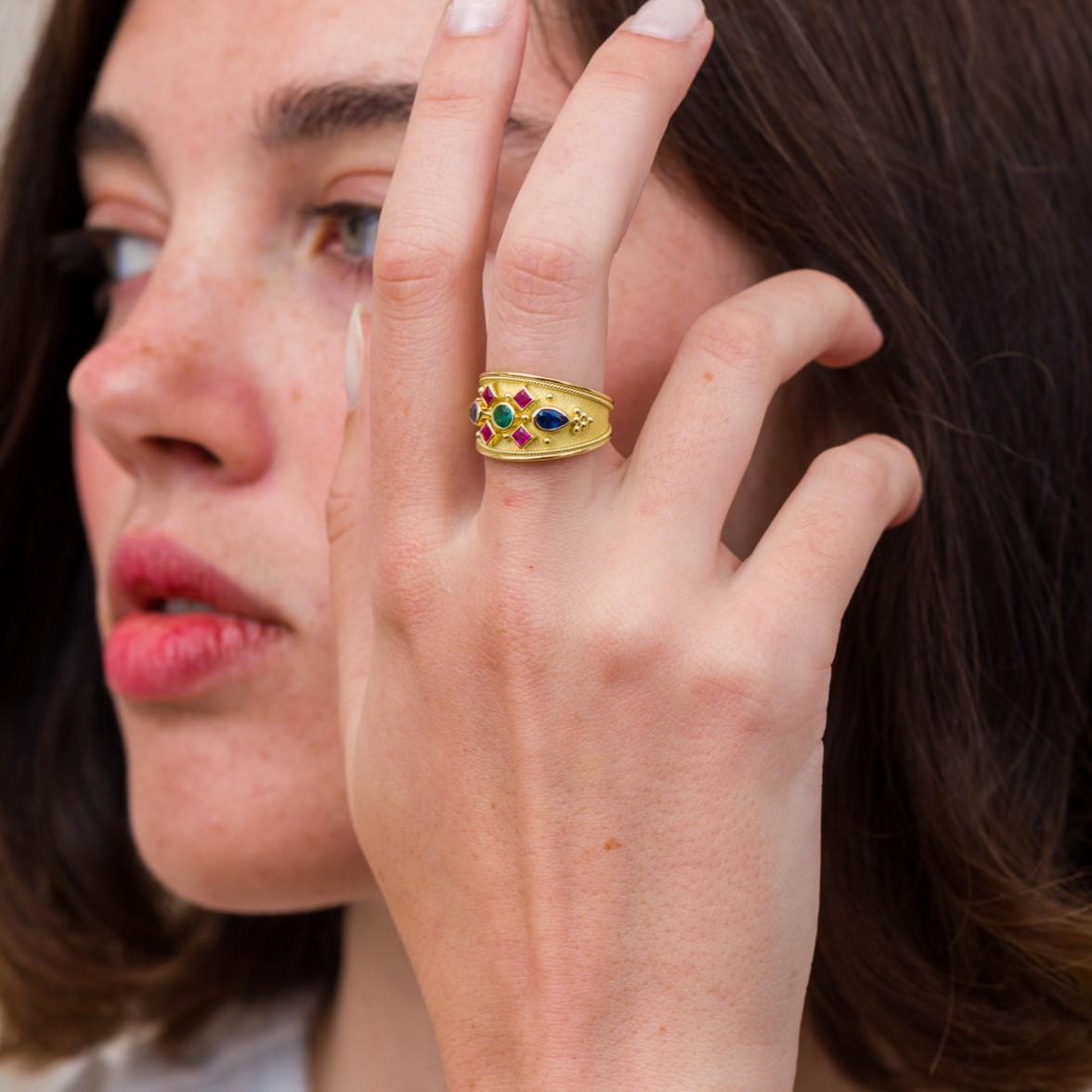 Step into the timeless allure of the Byzantine era with our Gold Byzantine Ring. Its regal design features a captivating Emerald at the center, encircled by four square Rubies, and crowned by two pear Sapphires, an exquisite piece that seamlessly