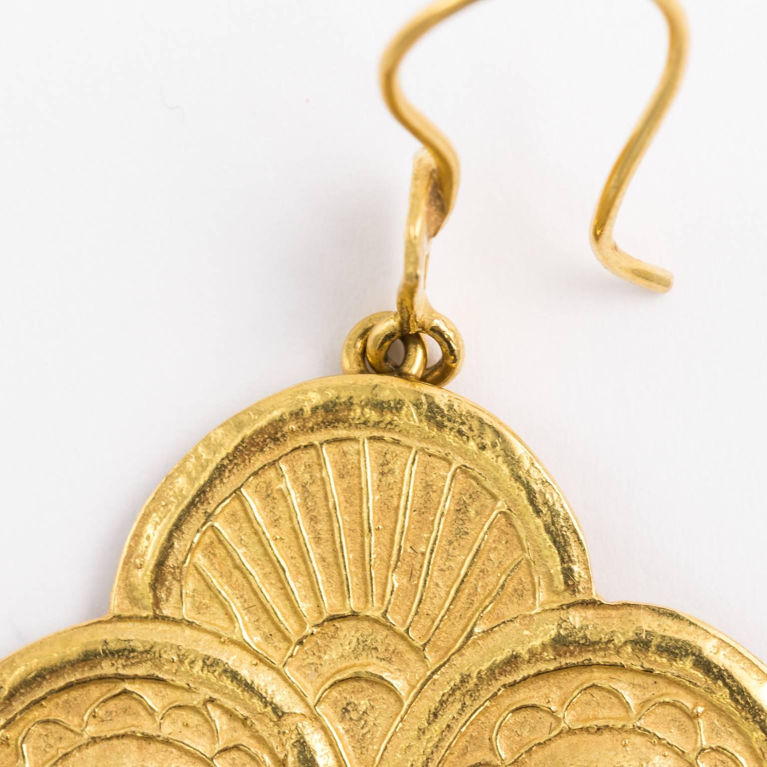 Circa mid 20th century Byzantine style earrings in 18 karat gold that features an intersecting circle design with three drops.
