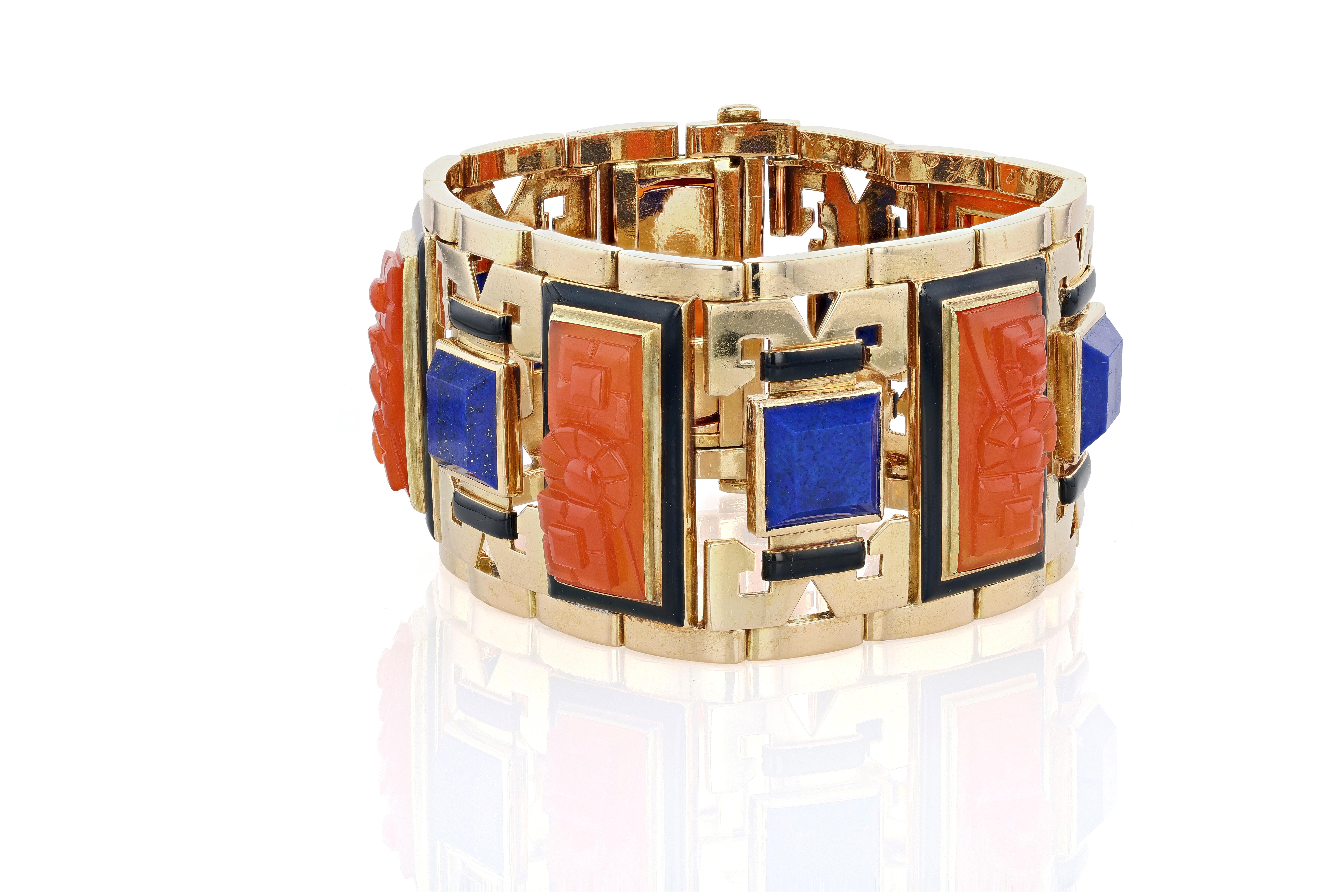 A circa 1940s 18 karat yellow gold, carved carnelian, lapis lazuli, and black enamel retro link bracelet in the ever popular Egyptian Revival style.

Though 