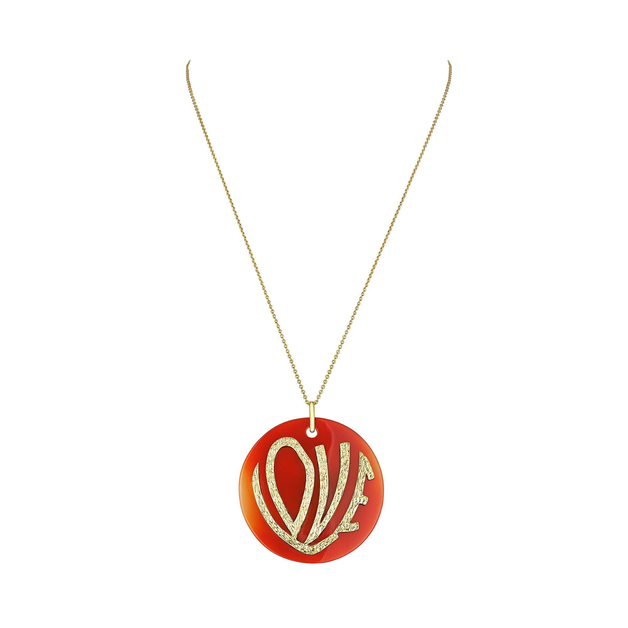 Show your love in full sight with this 1970's inspired large carnelian love pendant necklace.  This bold and colorful carnelian disc, with the hammered 18 karat yellow gold word LOVE stylishly applied to the front, makes this necklace a powerful and