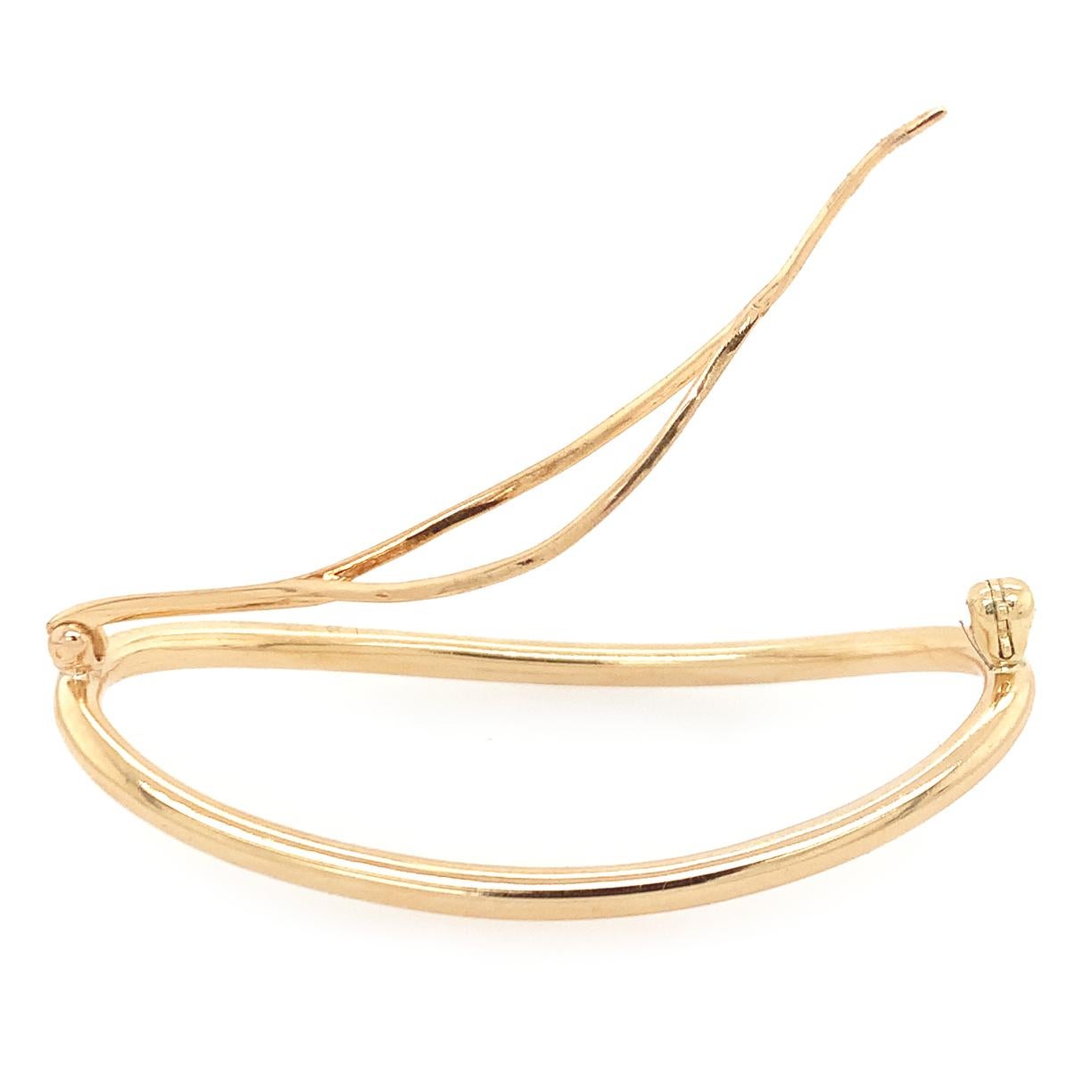 Chic gold barrette.  Made, signed  and numbered by CARTIER.  14K yellow gold.  Softly curved lines.  Easy-to-use mechanism.  2.20
