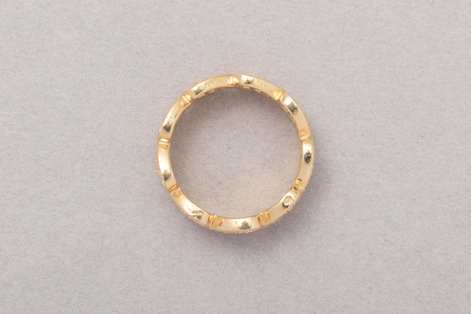 An 18 carat yellow gold eternity ring made out of 9 hearts connected to each other each set with 5 brilliant cut diamonds each (app. 1.8 ct in total) signed and numbered: Cartier, R06372, with French assay mark and master mark
weight: 6.28